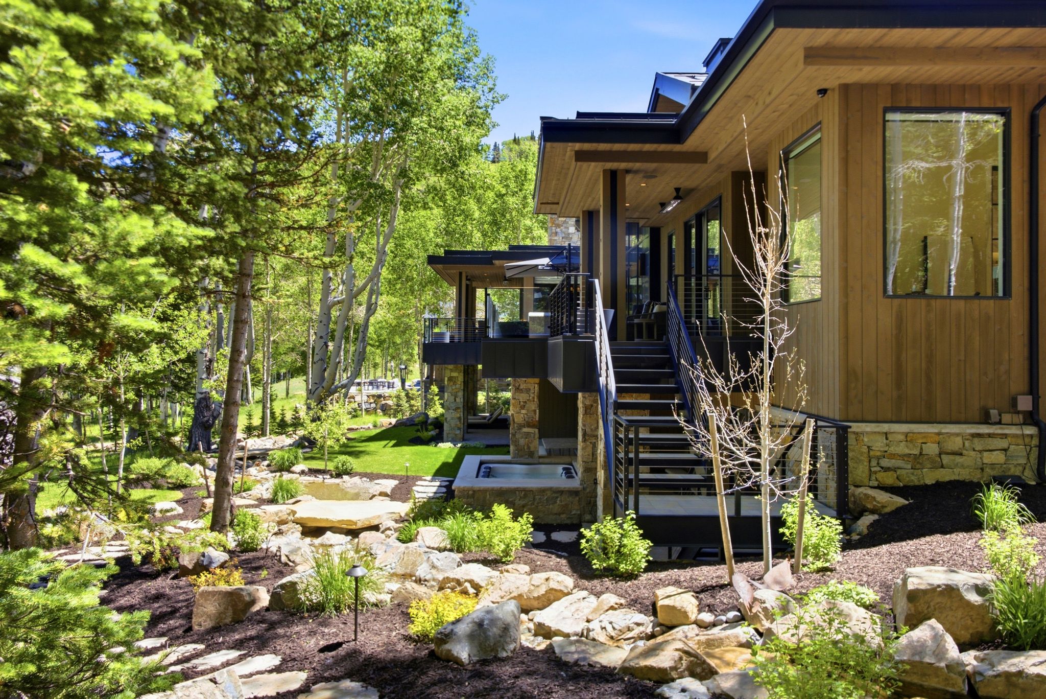 Modern exterior with natural wood siding and black trim accents