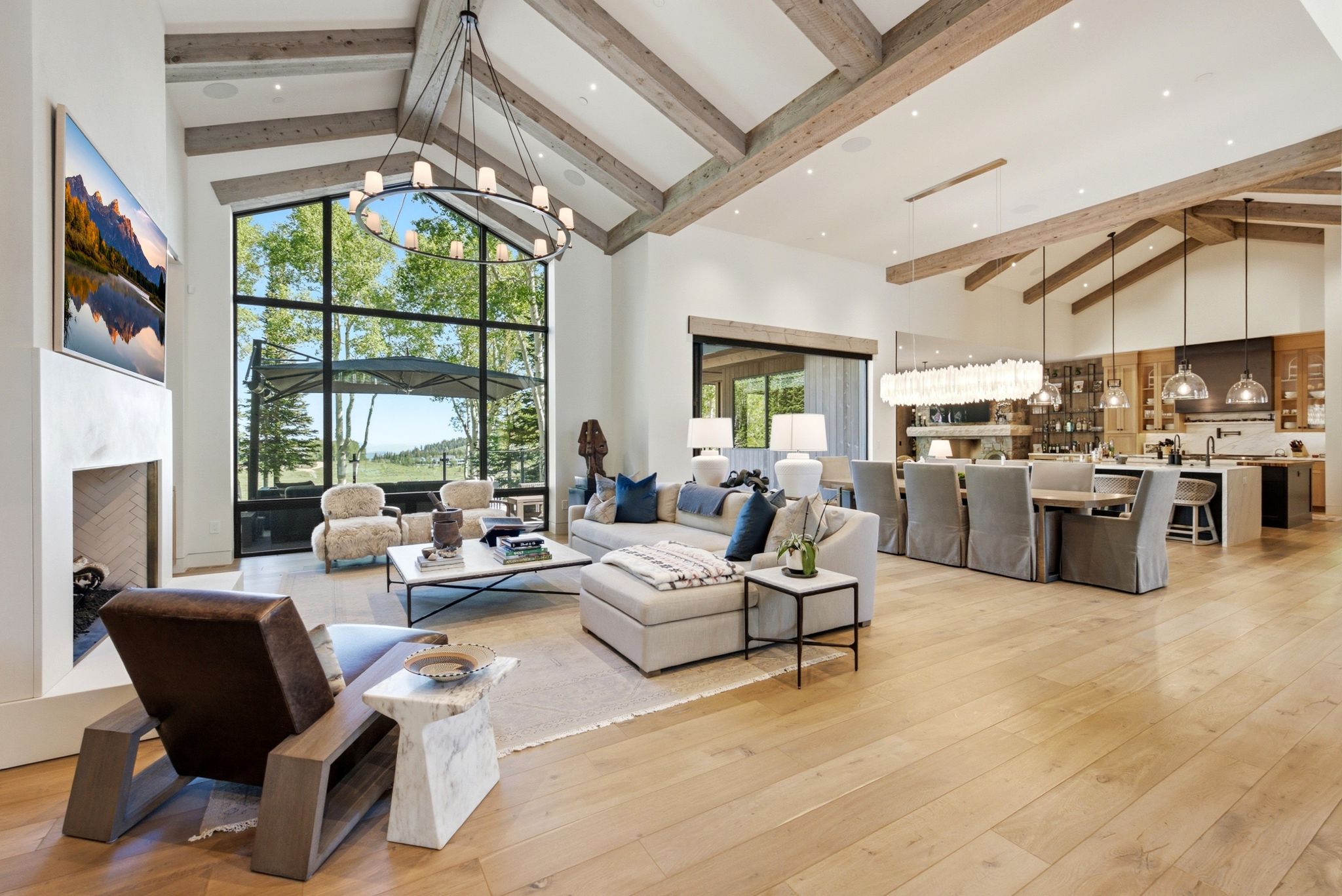Vaulted ceilings with exposed wood beams define this open-concept living space