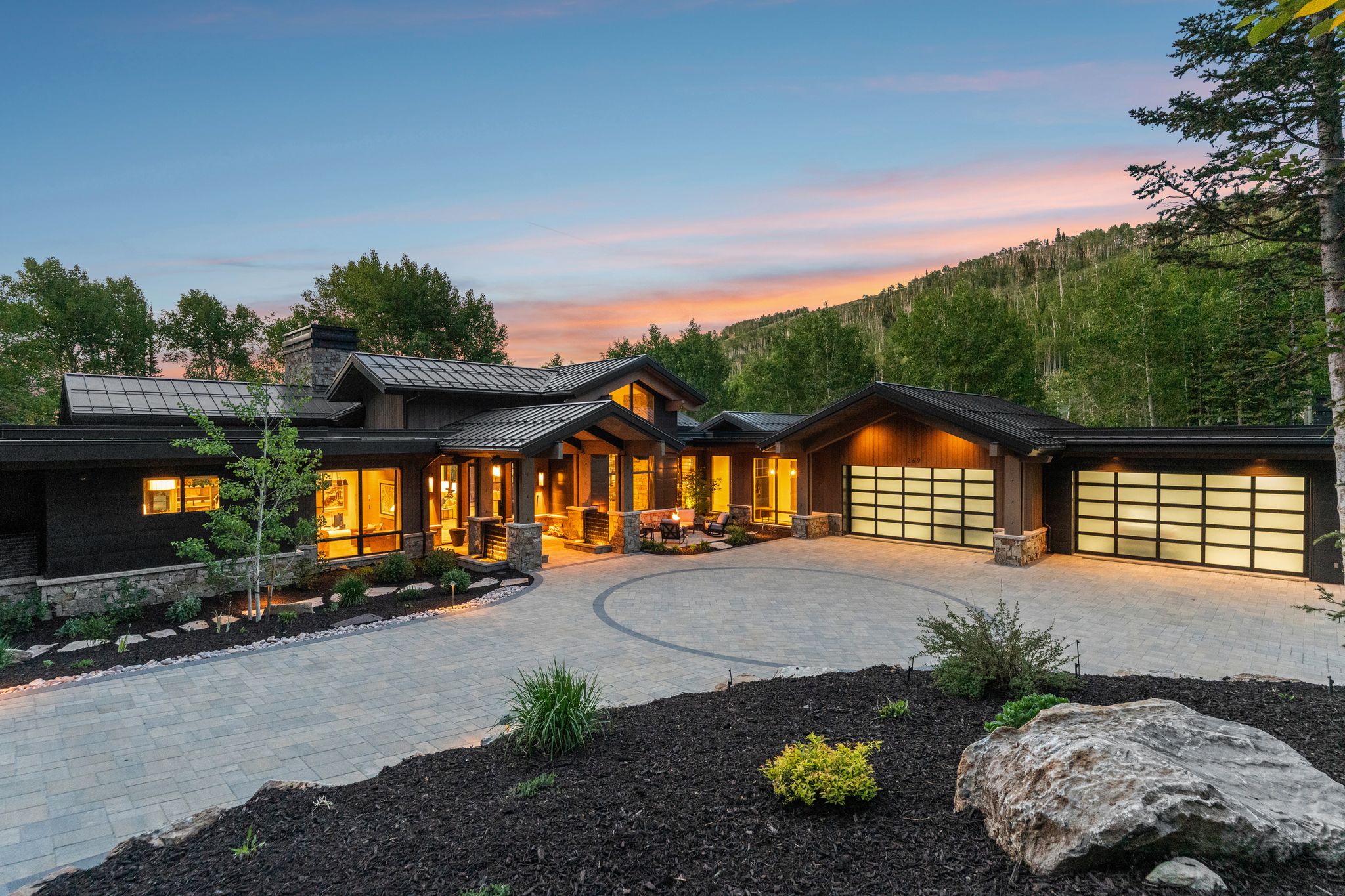 Contemporary architectural design featuring a dark wood facade and stone accents