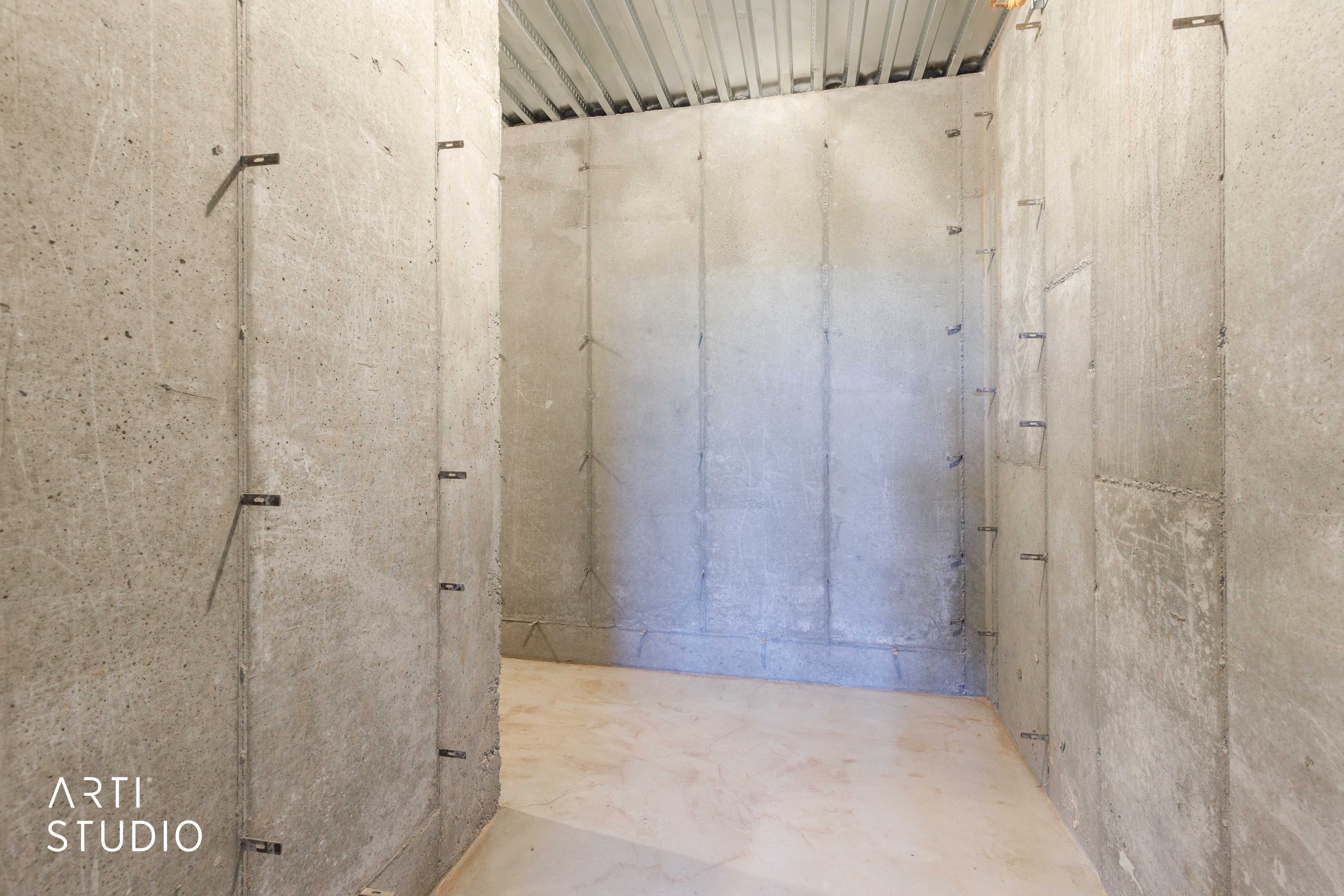 Concrete wall construction with exposed corrugated metal ceiling