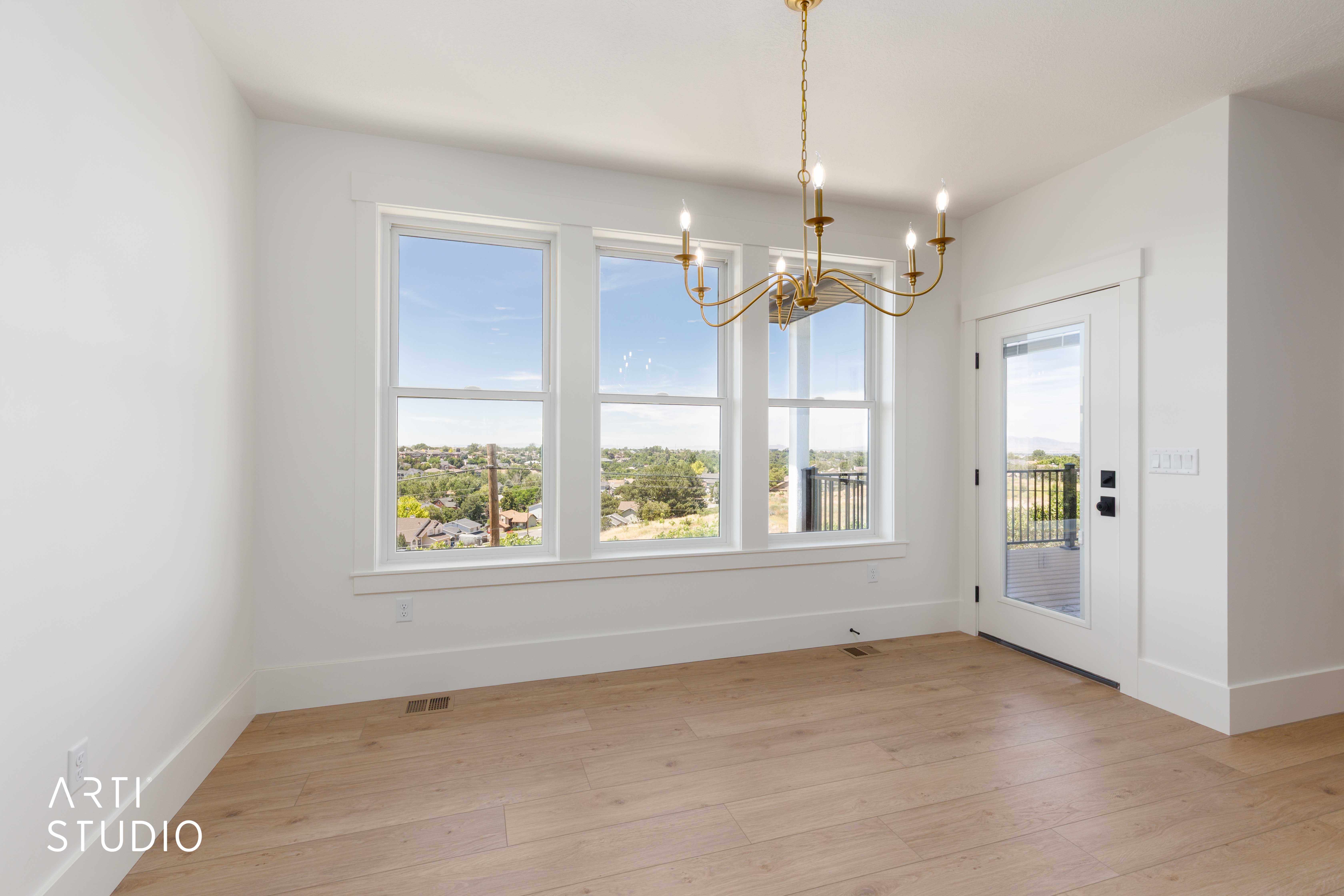 Light wood-finish flooring complements the white walls and trim