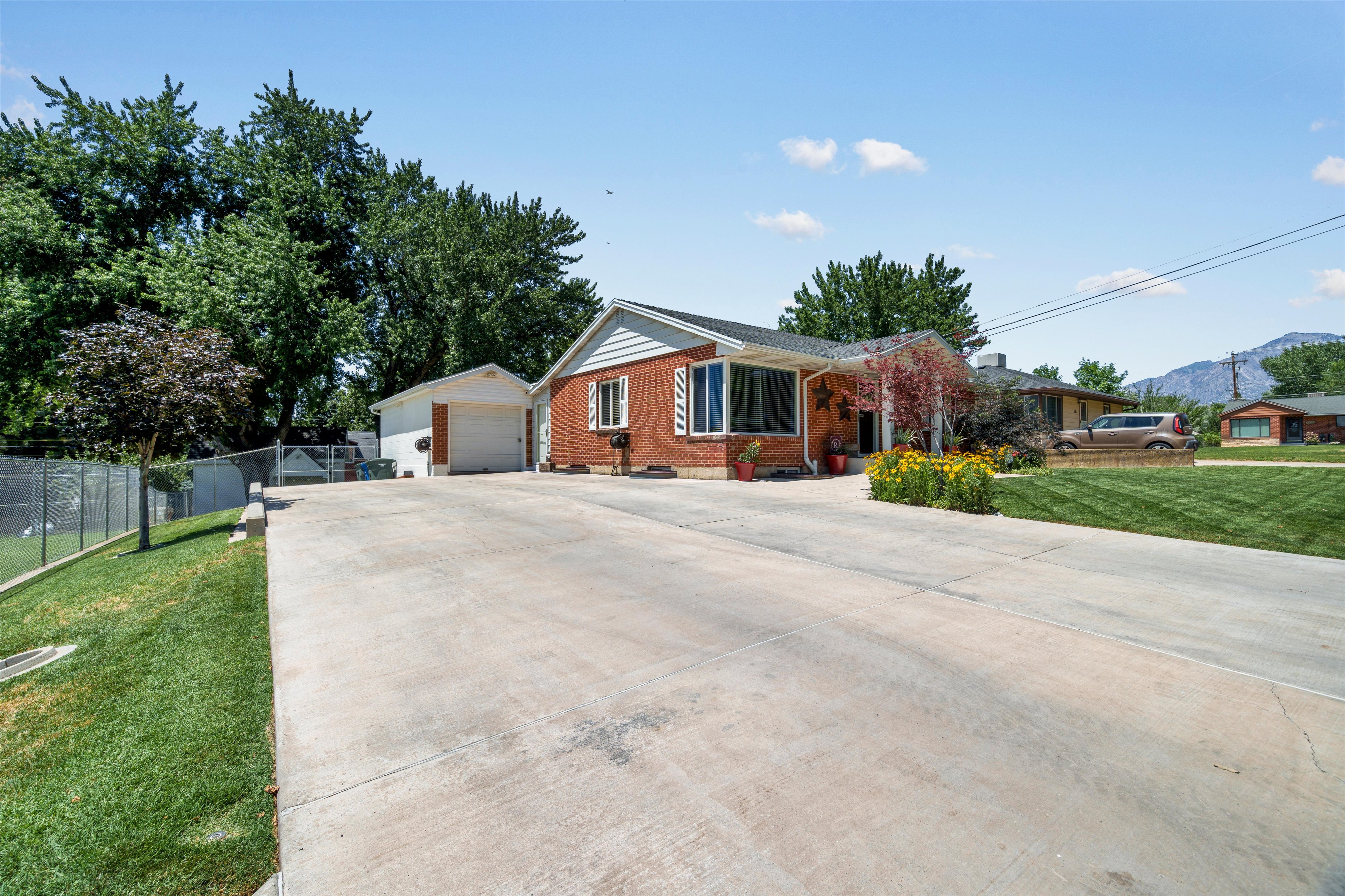 Red brick exterior with white trim and a gabled roofline. Large RV parking