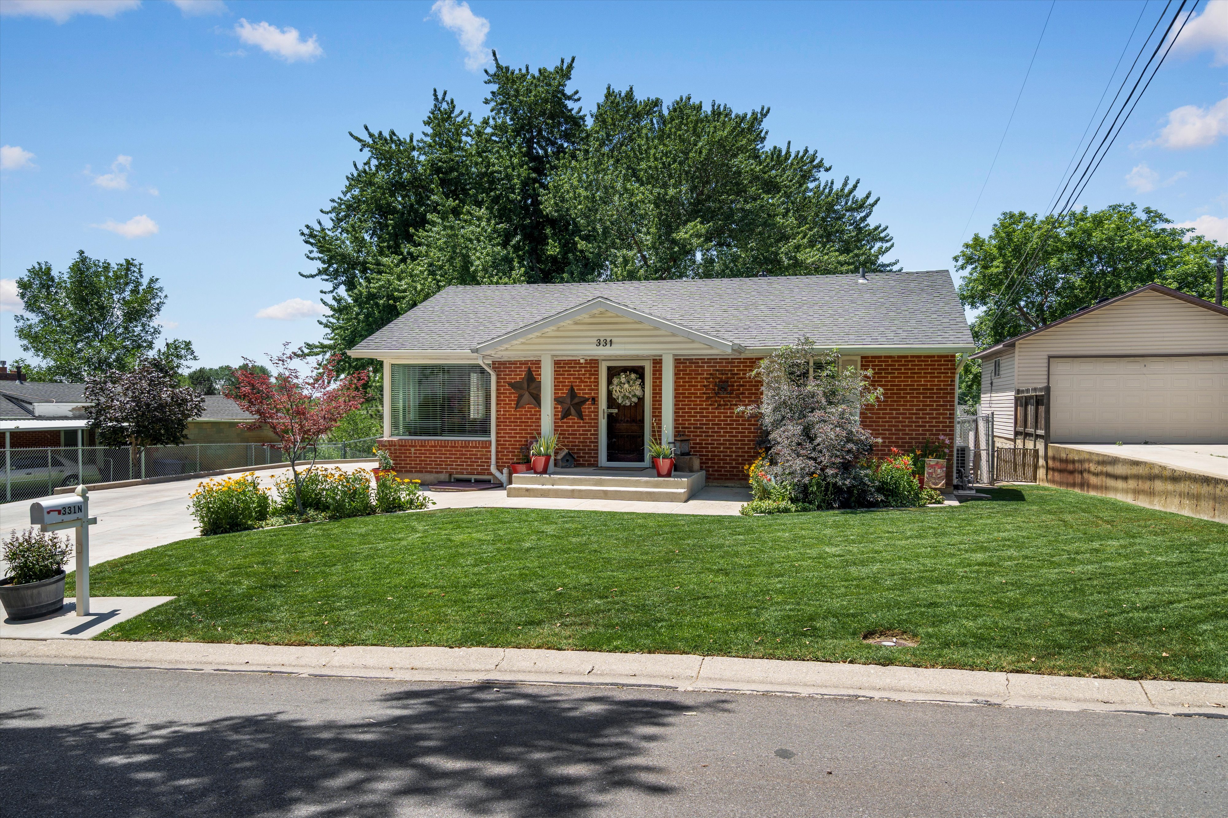 Brick facade residence with a gabled roof and covered front entry
