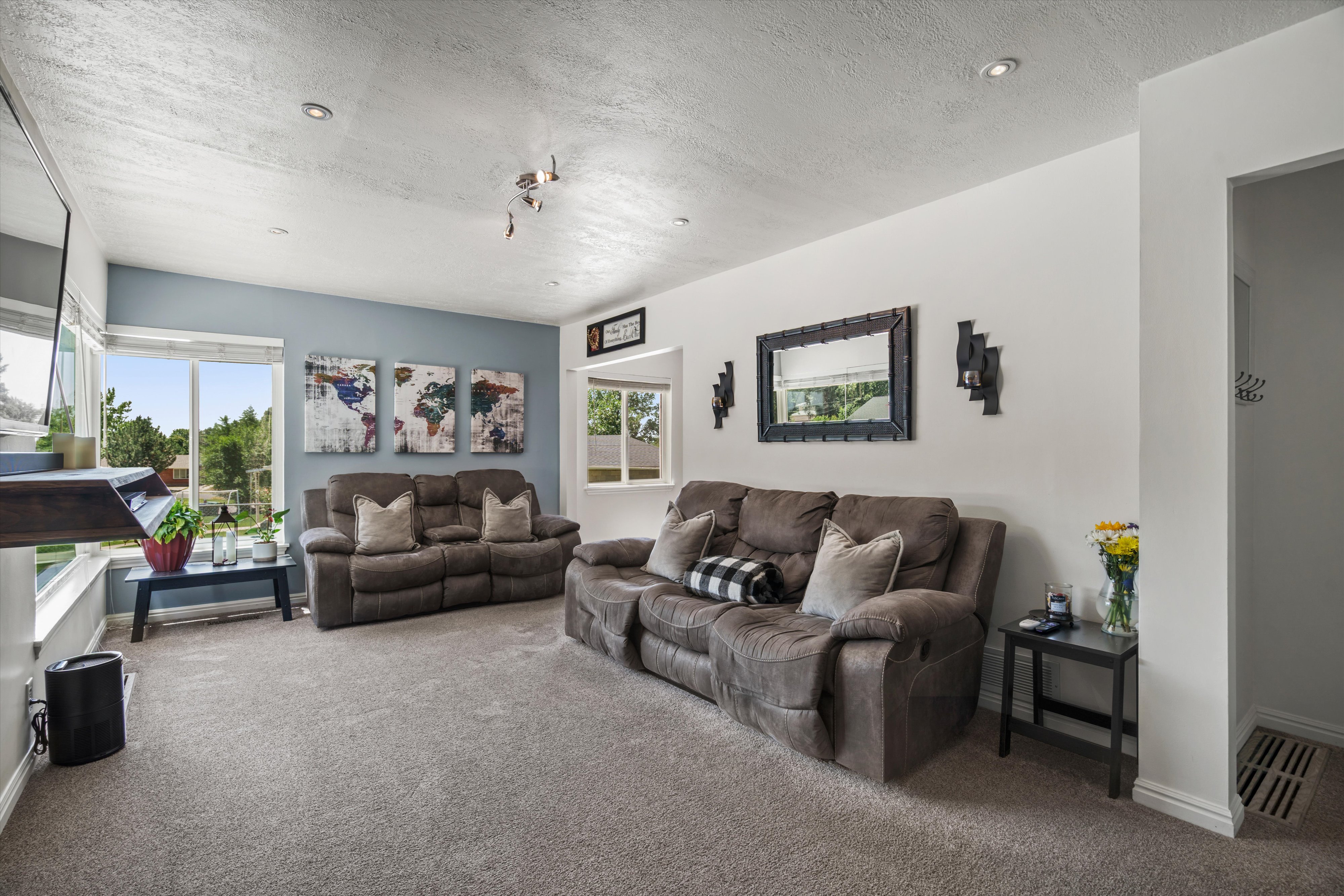 Carpeted living space featuring recessed lighting and abundant natural light from multiple windows
