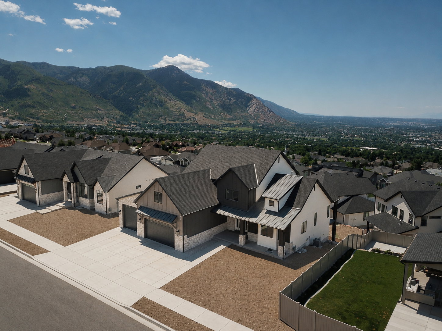 New construction featuring a modern farmhouse aesthetic with a prominent mountain backdrop
