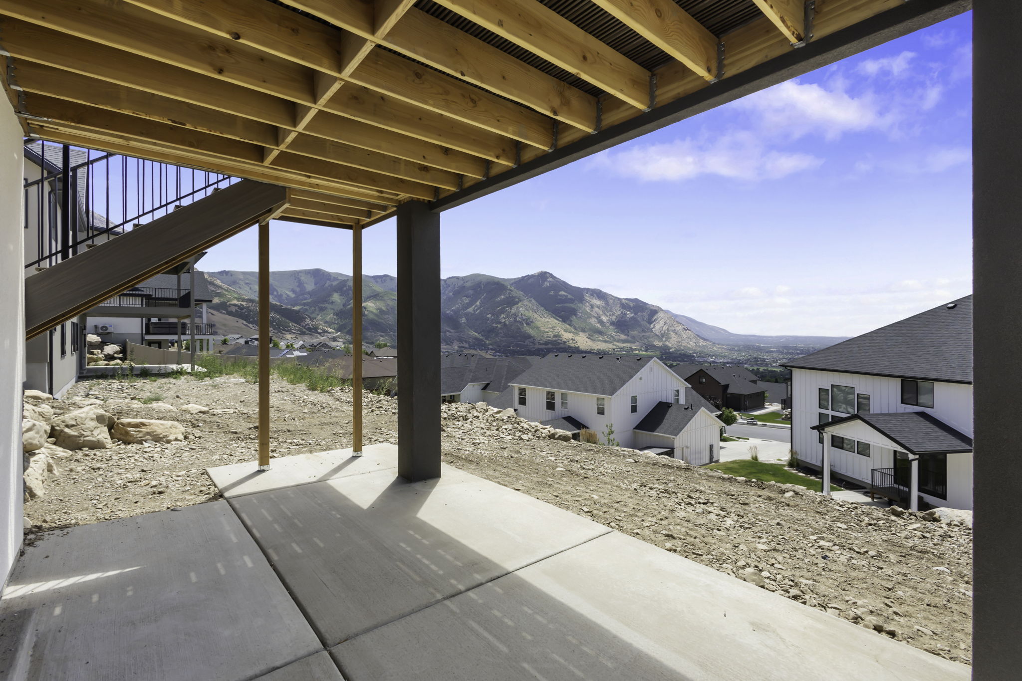 Covered concrete patio with exposed wood ceiling joists