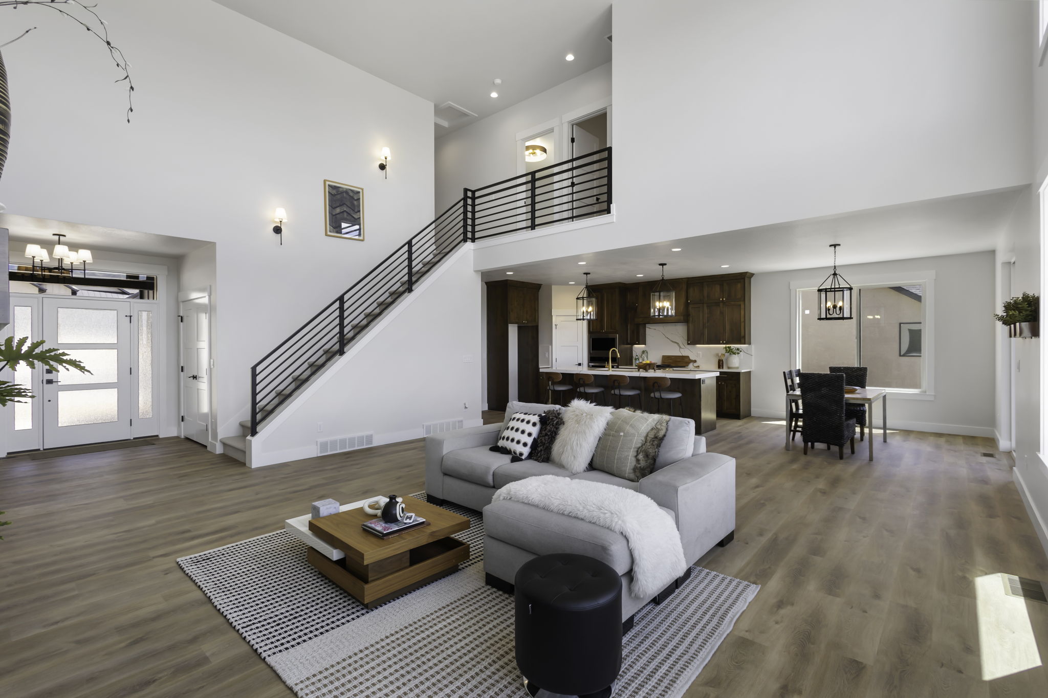 Bright, open-concept living space featuring wood-finish flooring throughout