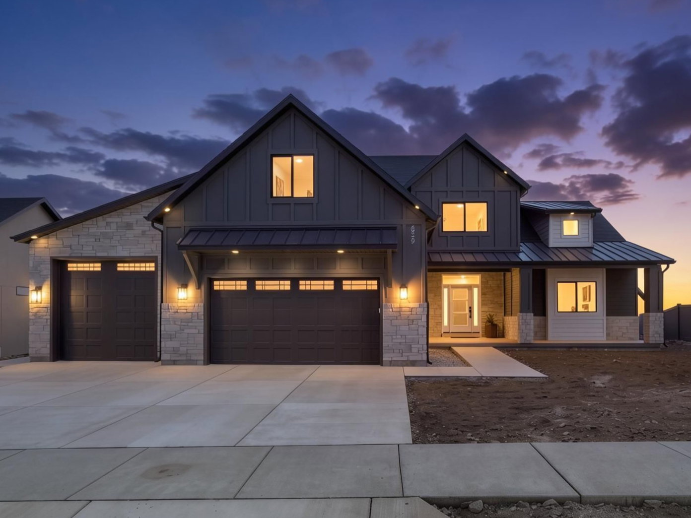 Modern farmhouse exterior with board and batten siding, stone accents, and a metal roof
