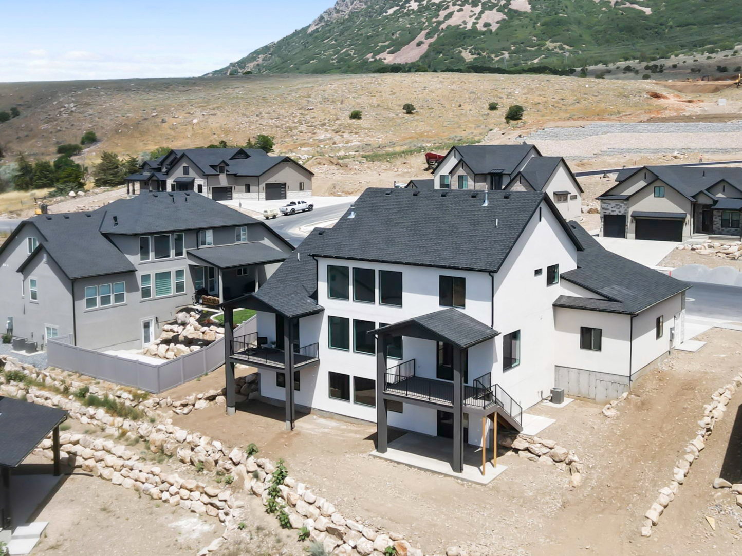Contemporary two-story residence featuring a white exterior with black window frames