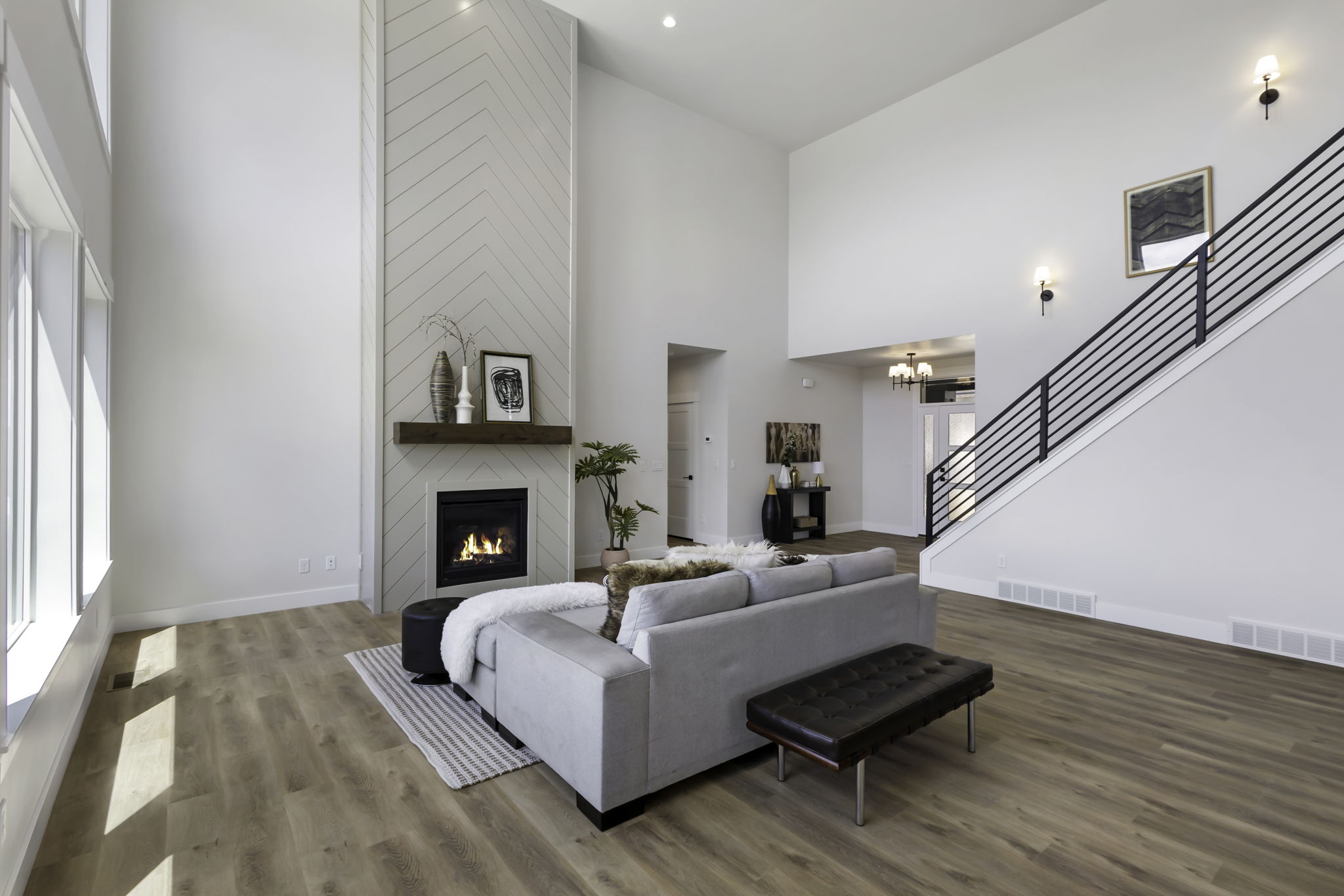 Two-story living area featuring a fireplace with a decorative shiplap surround and wood mantel
