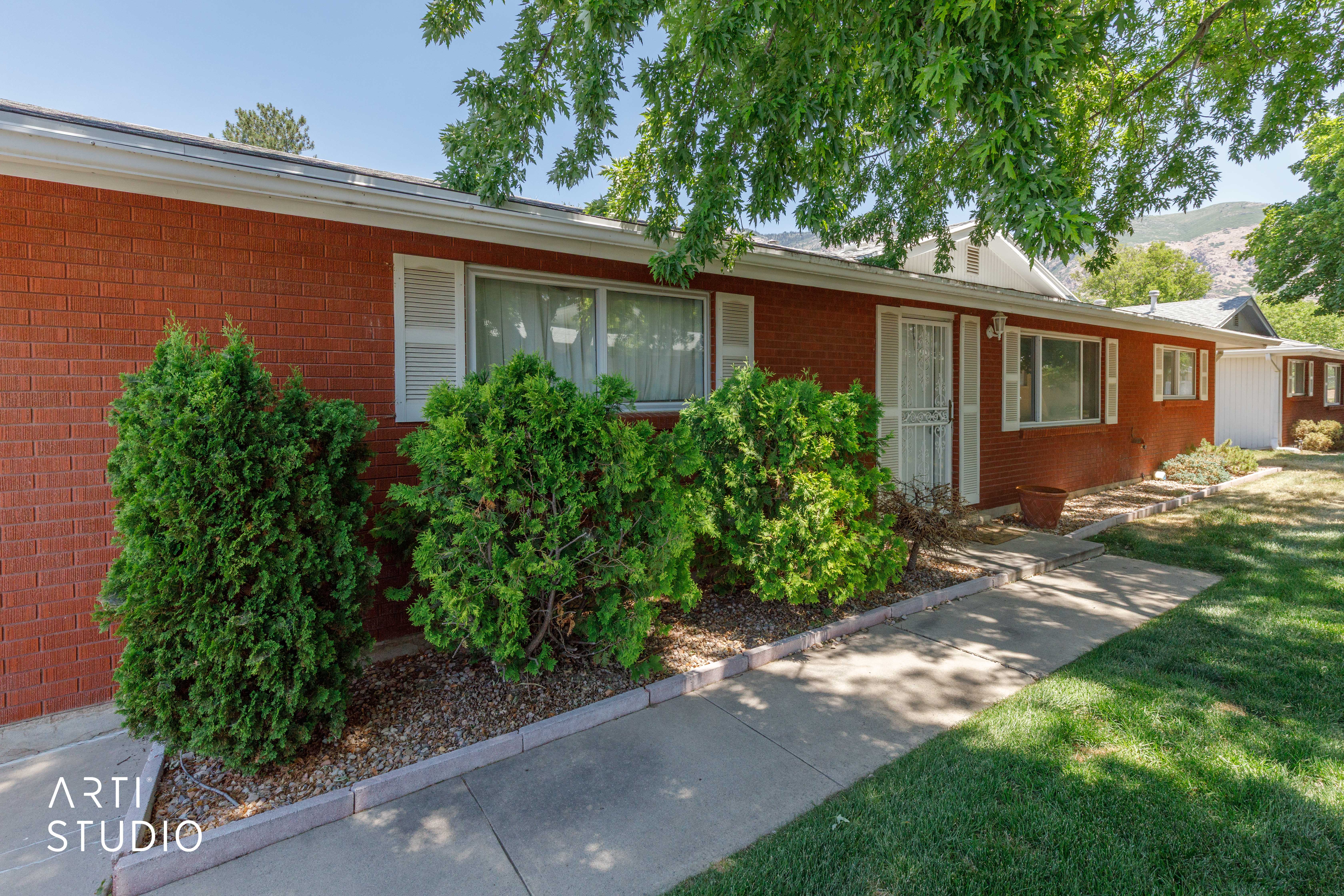 Brick exterior with white window shutters and trim