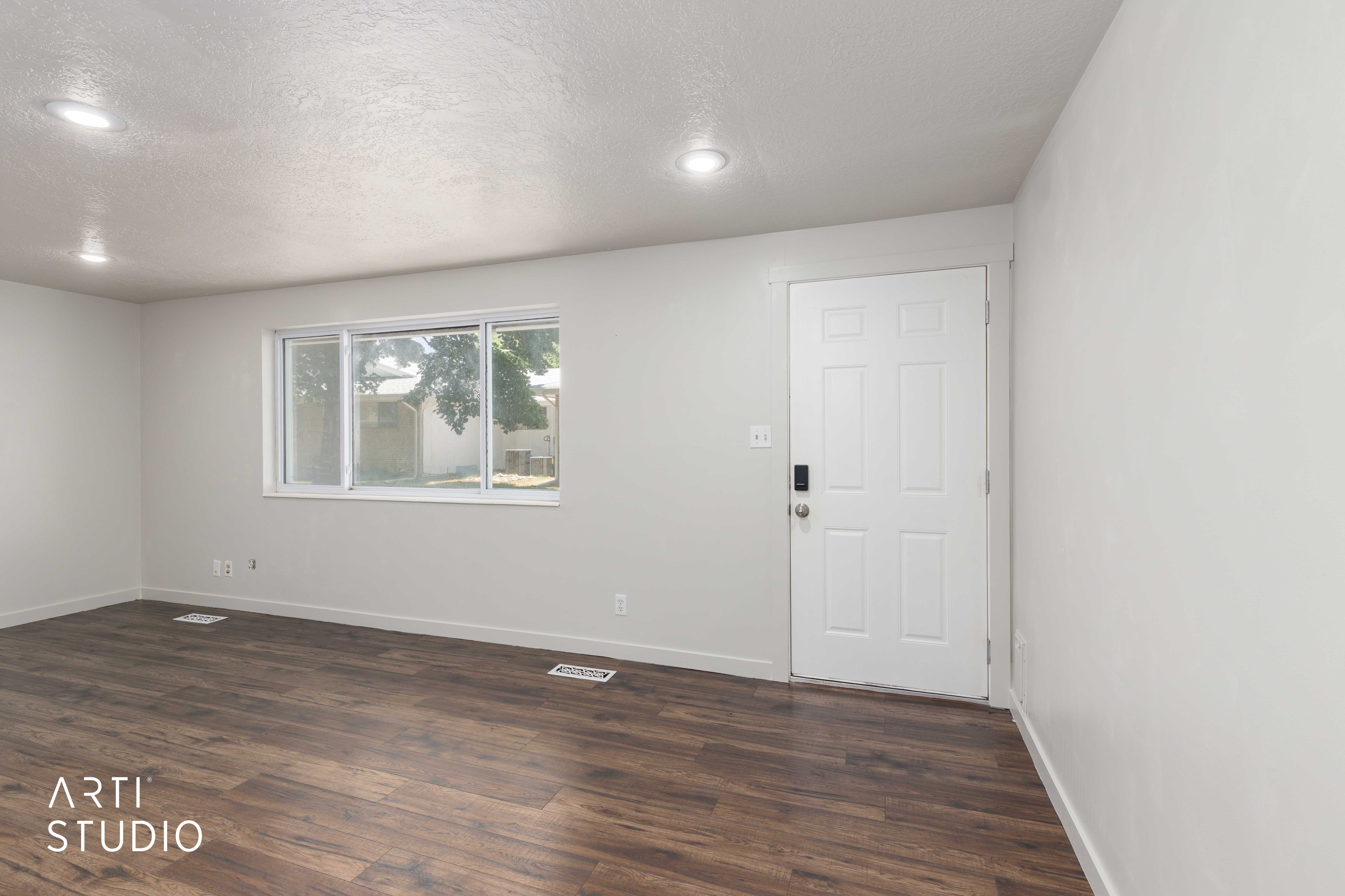 Entryway featuring a white paneled door with smart lock hardware, wood-finish flooring, a large window, recessed lighting, and white baseboards