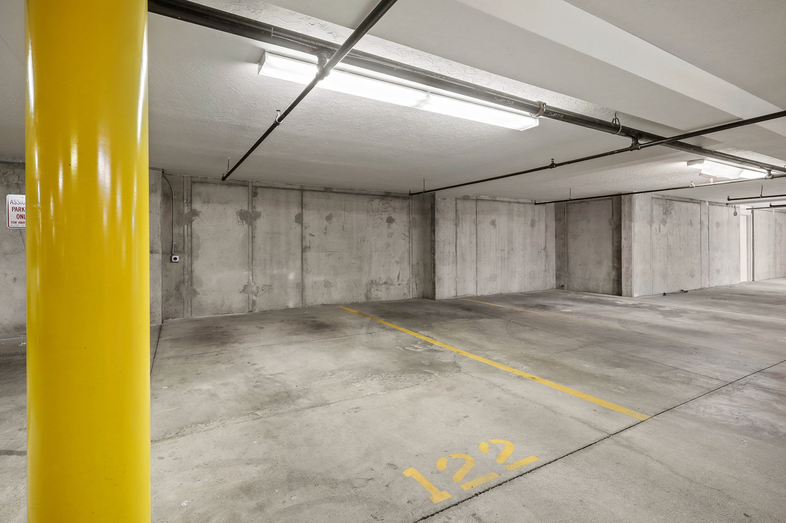 Dedicated underground parking spot with 220V (50 amp) outlet for an EV charging station