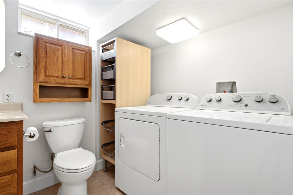 Full-size laundry appliances with additional storage shelving