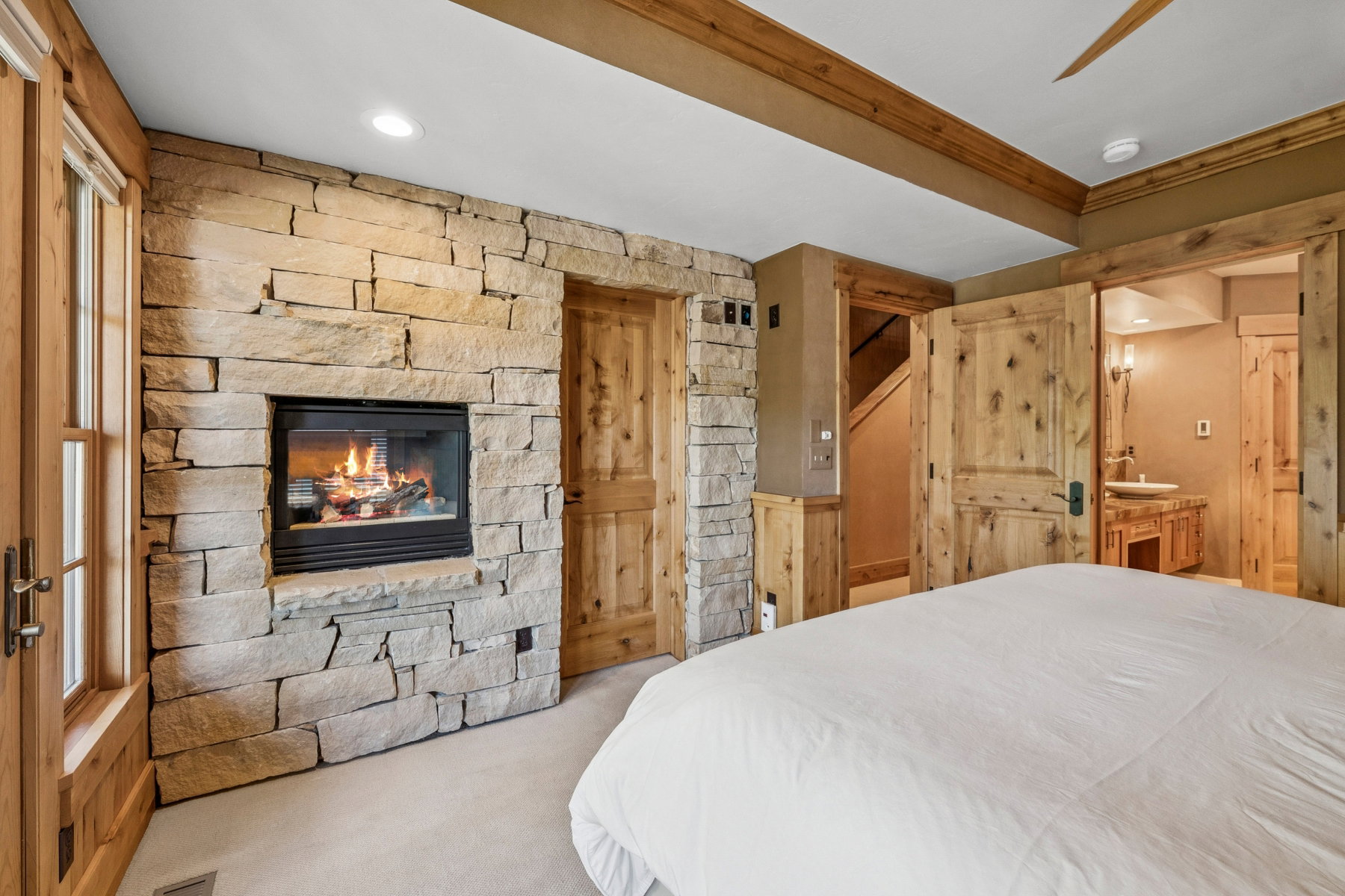 Stone-clad fireplace feature wall with a hearth