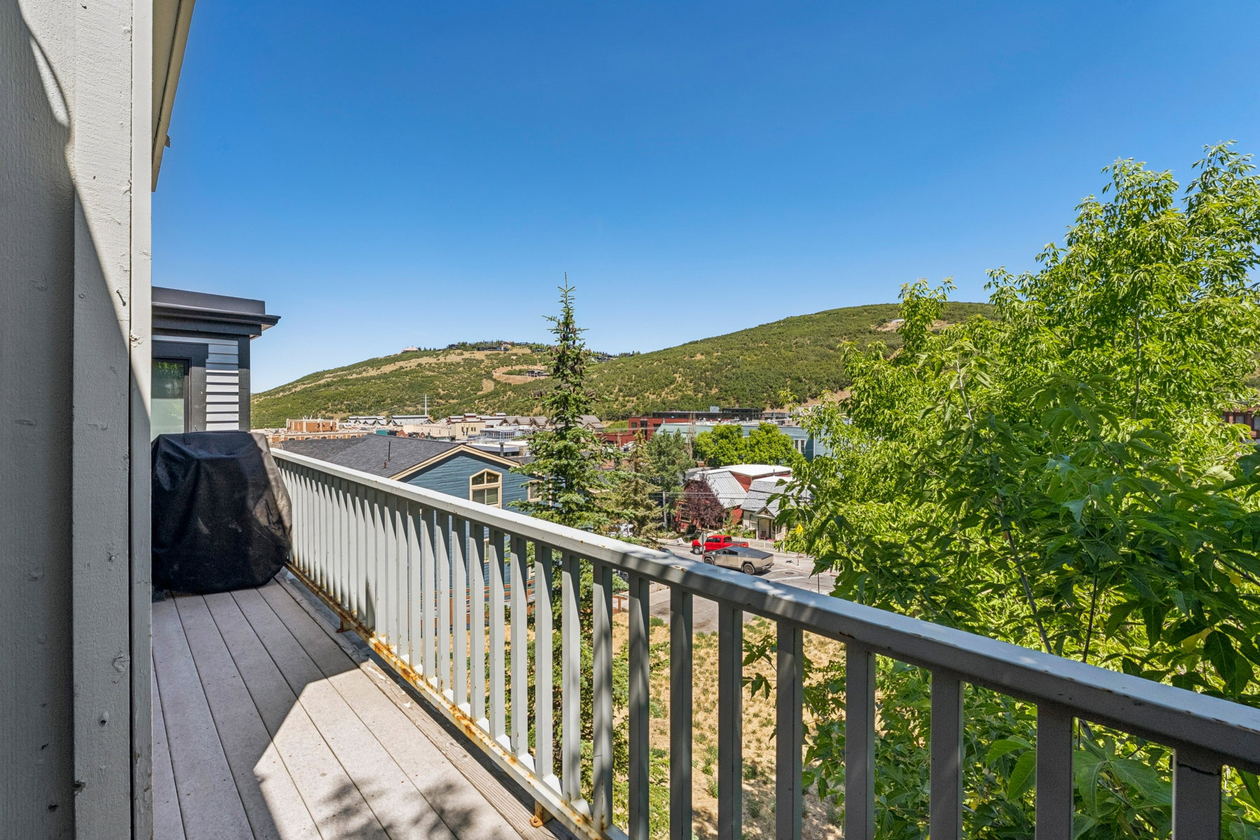 Outdoor balcony with composite decking and a painted railing