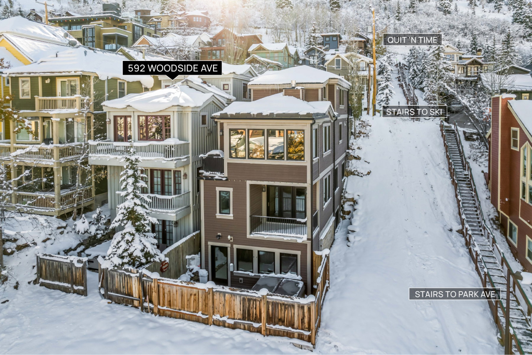 Contemporary multi-level residence with dark siding and multiple balconies