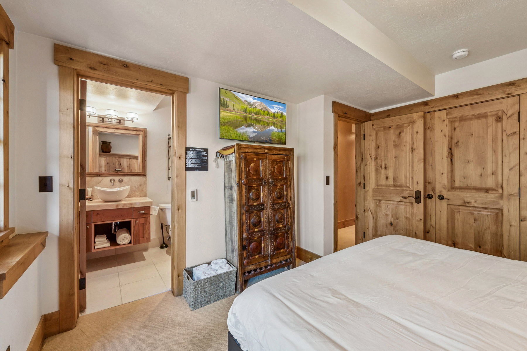 Bedroom featuring natural wood-finish trim and doors