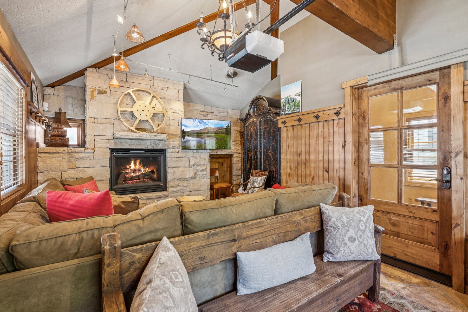Vaulted ceiling with exposed wood beams and track lighting