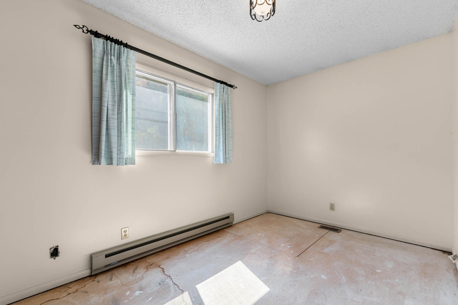 Neutral wall paint paired with a textured ceiling