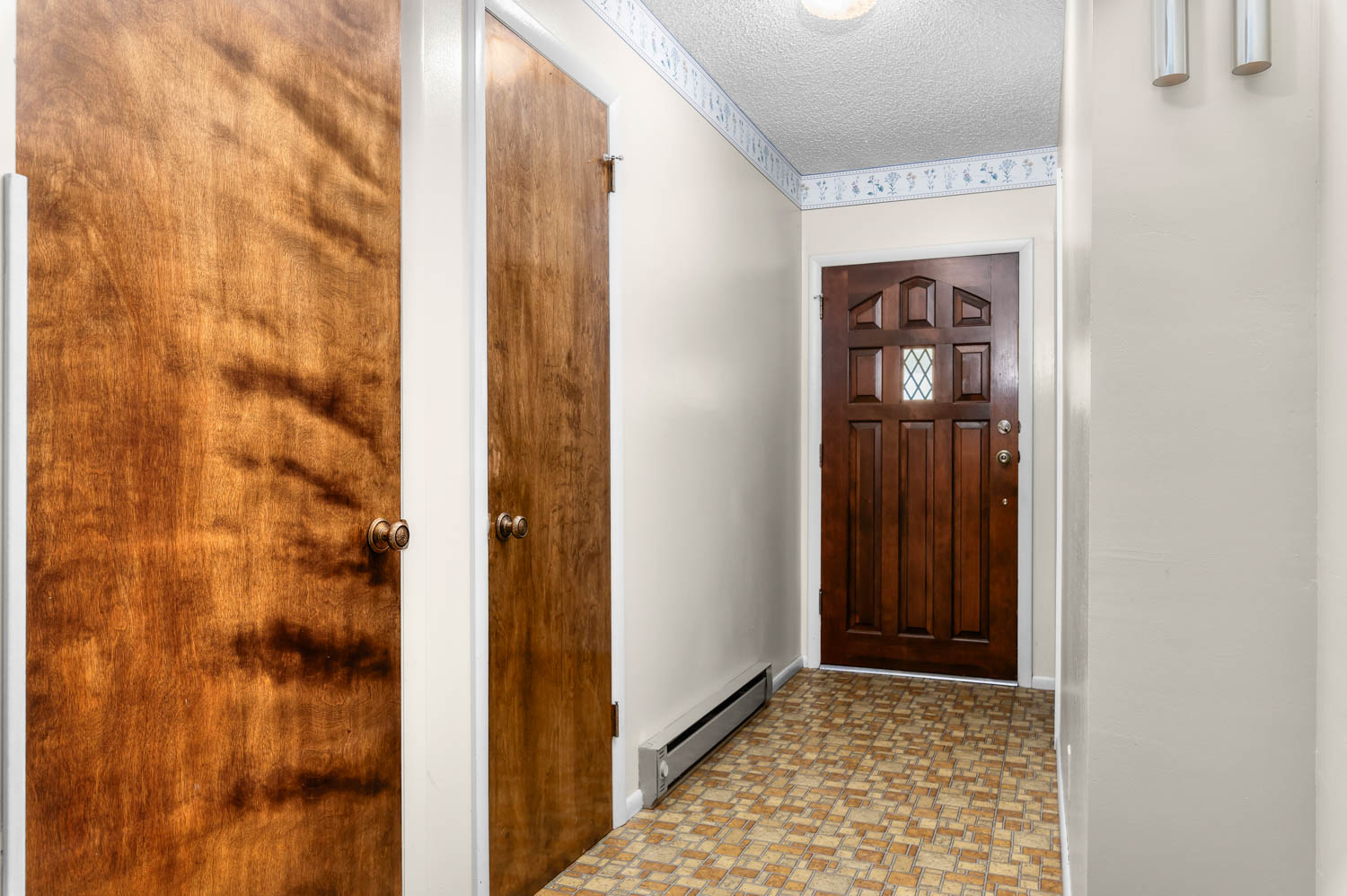 Paneled entry door with diamond-patterned glass insert