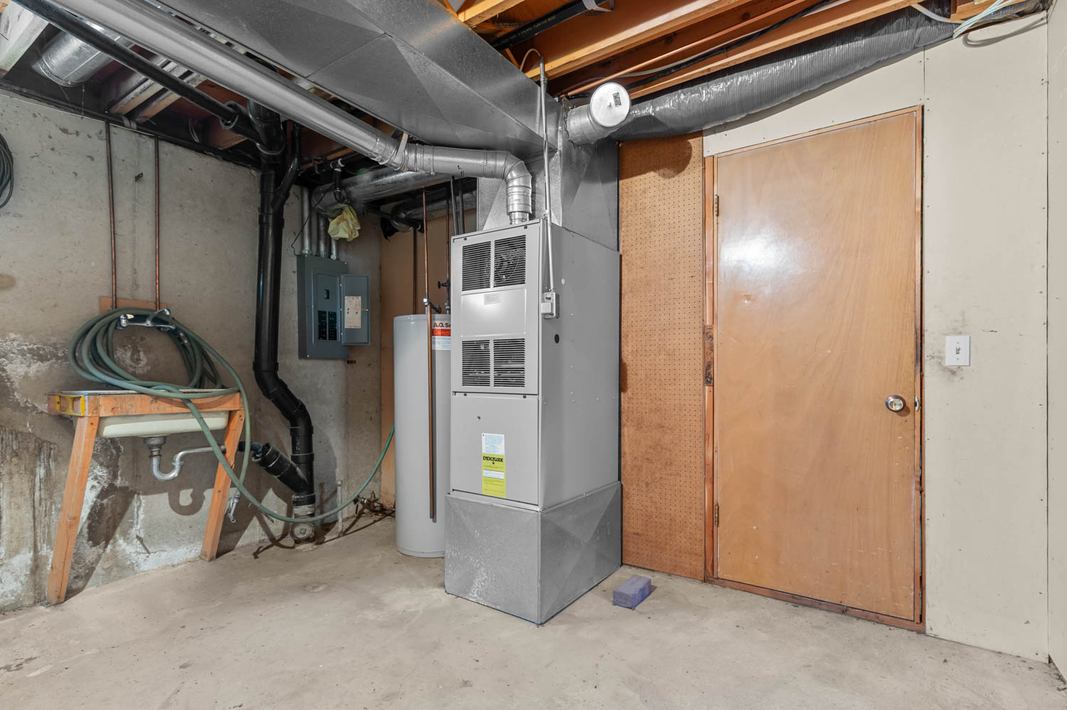 Utility space featuring a furnace, water heater, and electrical panel