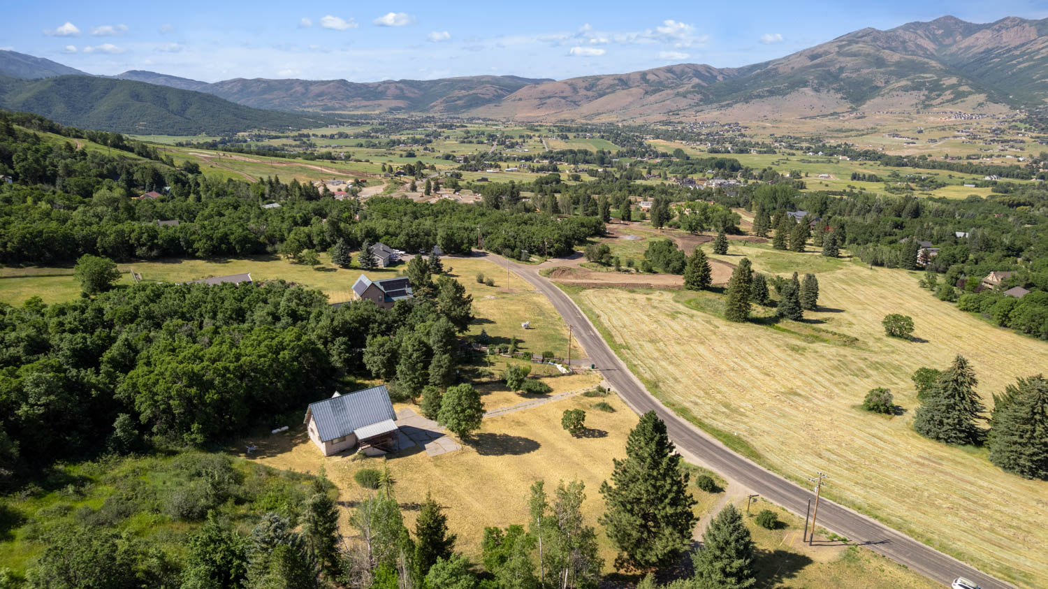 Expansive rural setting featuring a winding road and open fields