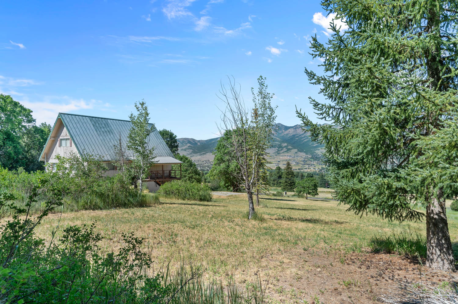 A-frame style residence featuring a metal roof and an elevated covered porch
