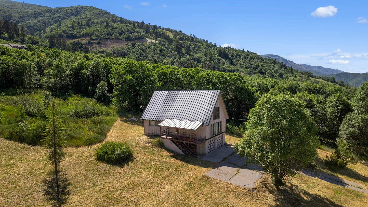 A-frame property with a metal roof and an upper-level balcony