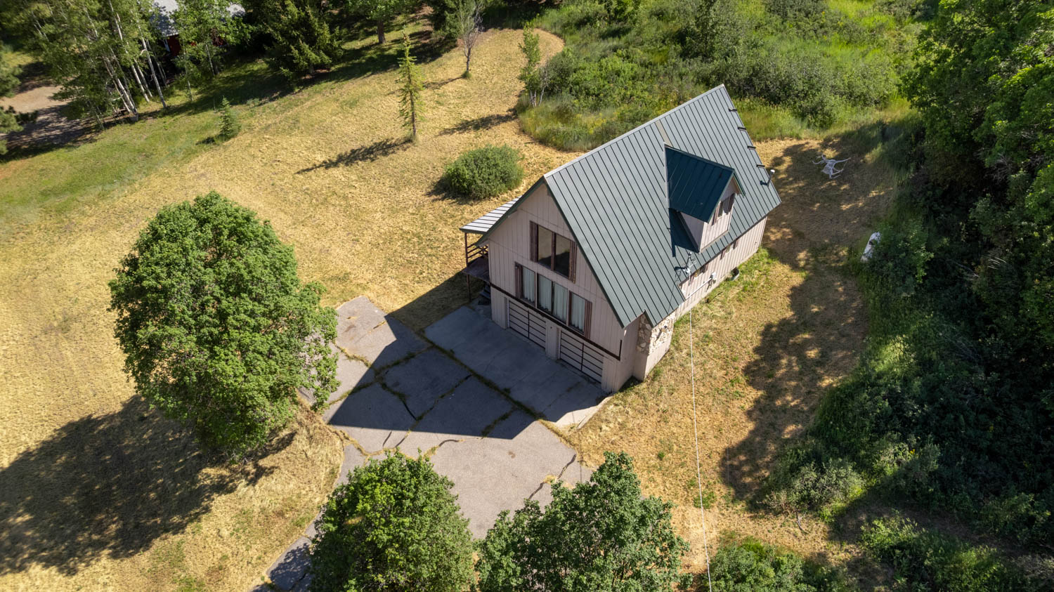 A-frame style residence featuring a metal roof and a dormer window