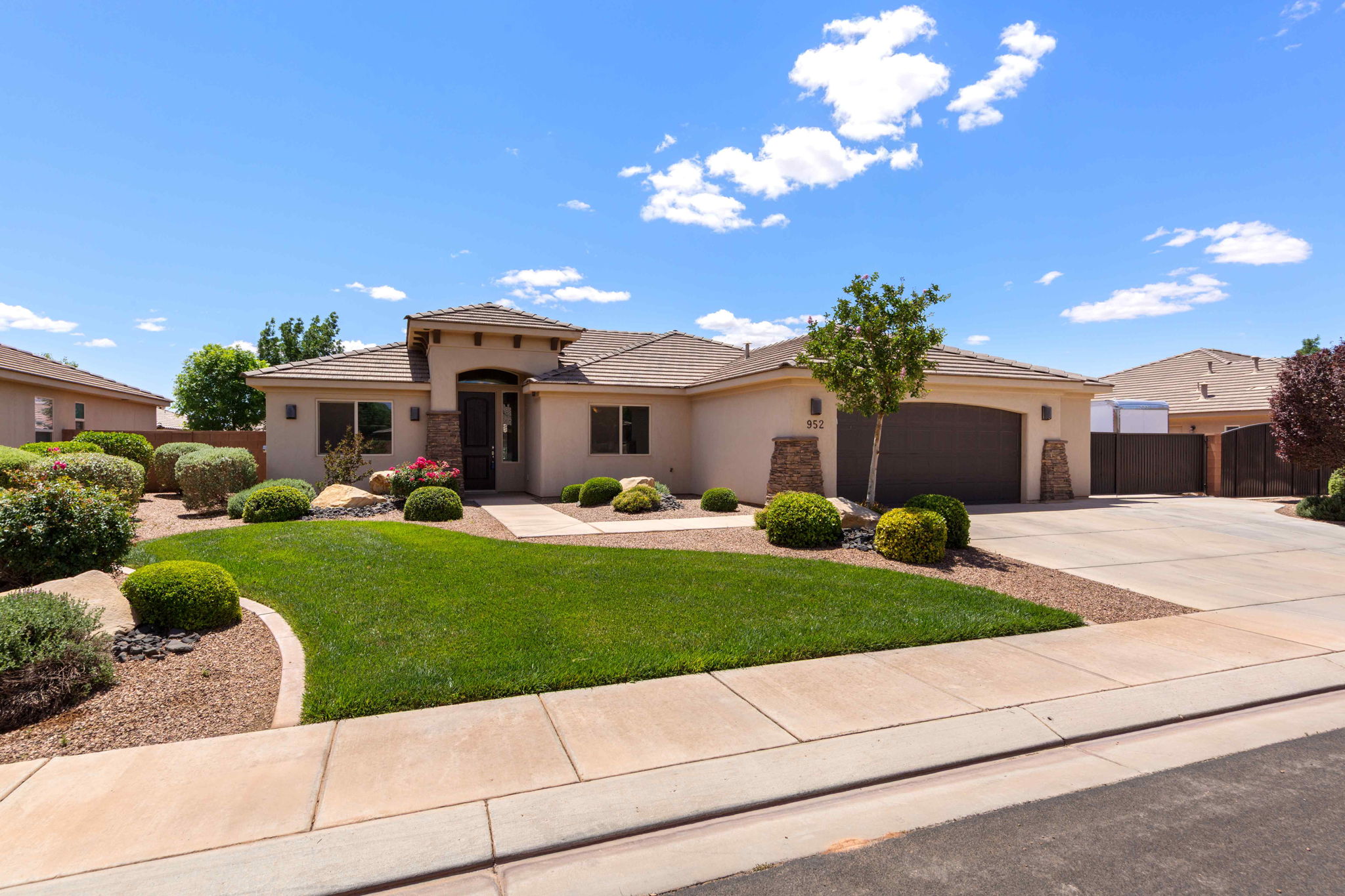 Stucco exterior with stone accents and a tiled roof