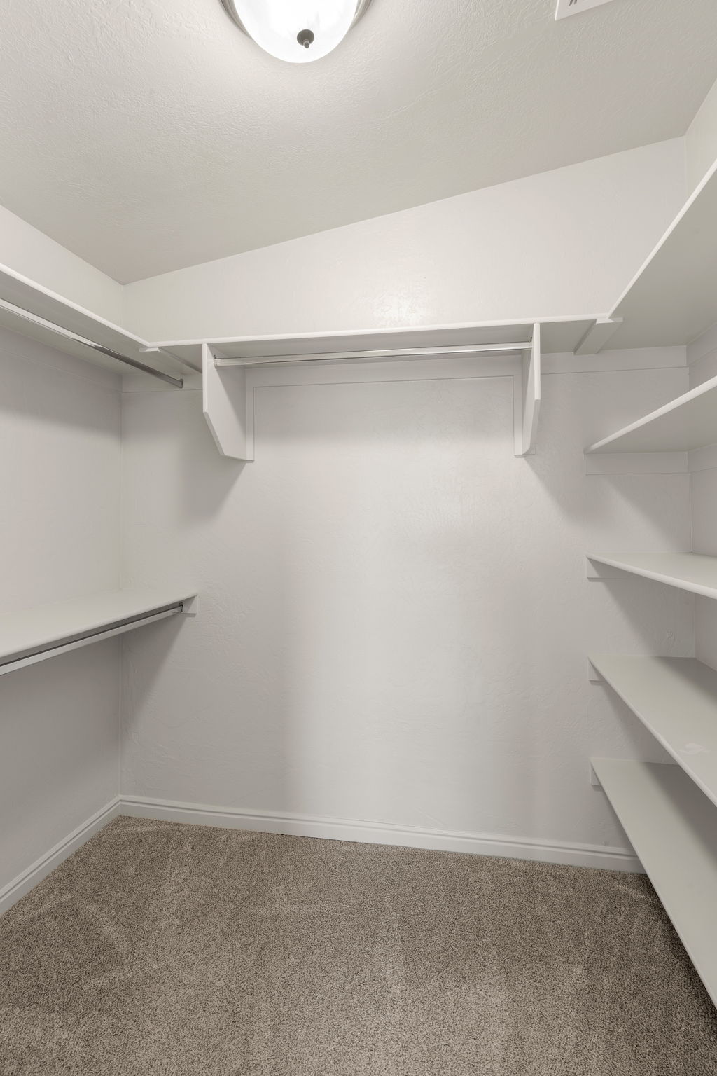 Walk-in closet with integrated shelving and hanging rods