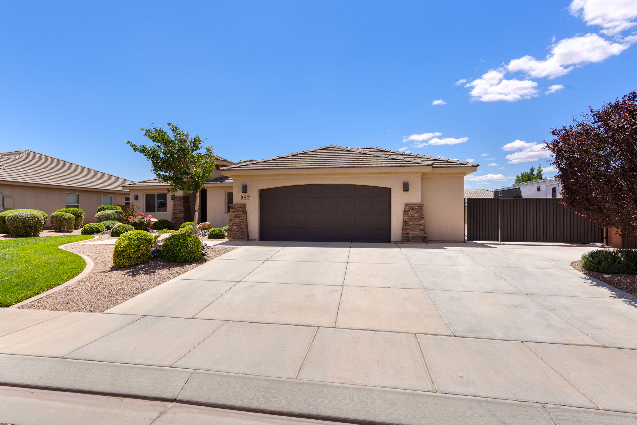 Stucco exterior with stone accents and a tile roof