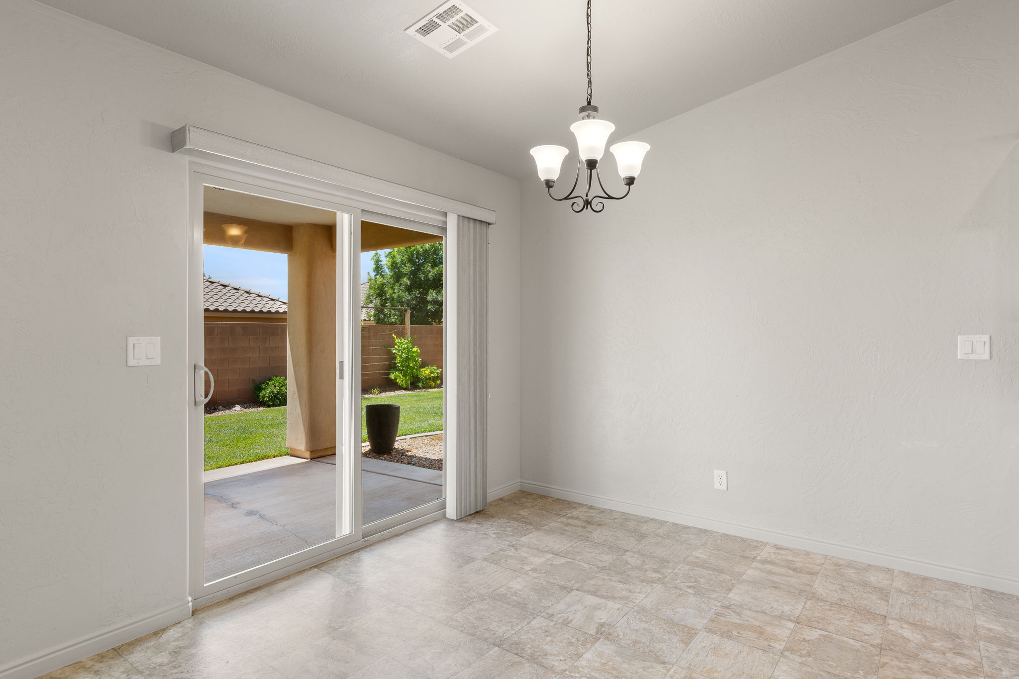 Interior space featuring tile flooring, a multi-light chandelier, and light-toned walls