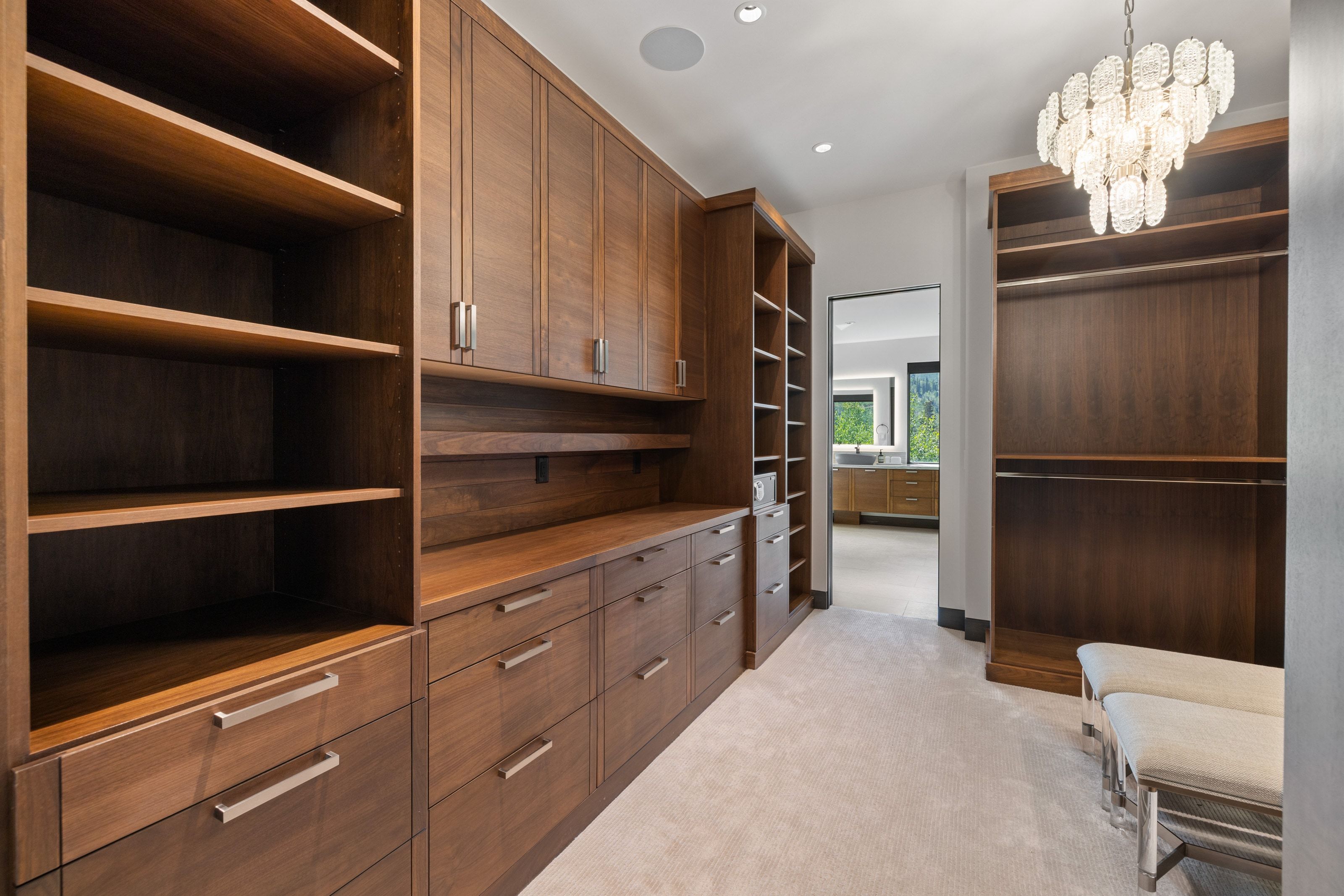 Custom wood-finish cabinetry and shelving with brushed nickel hardware