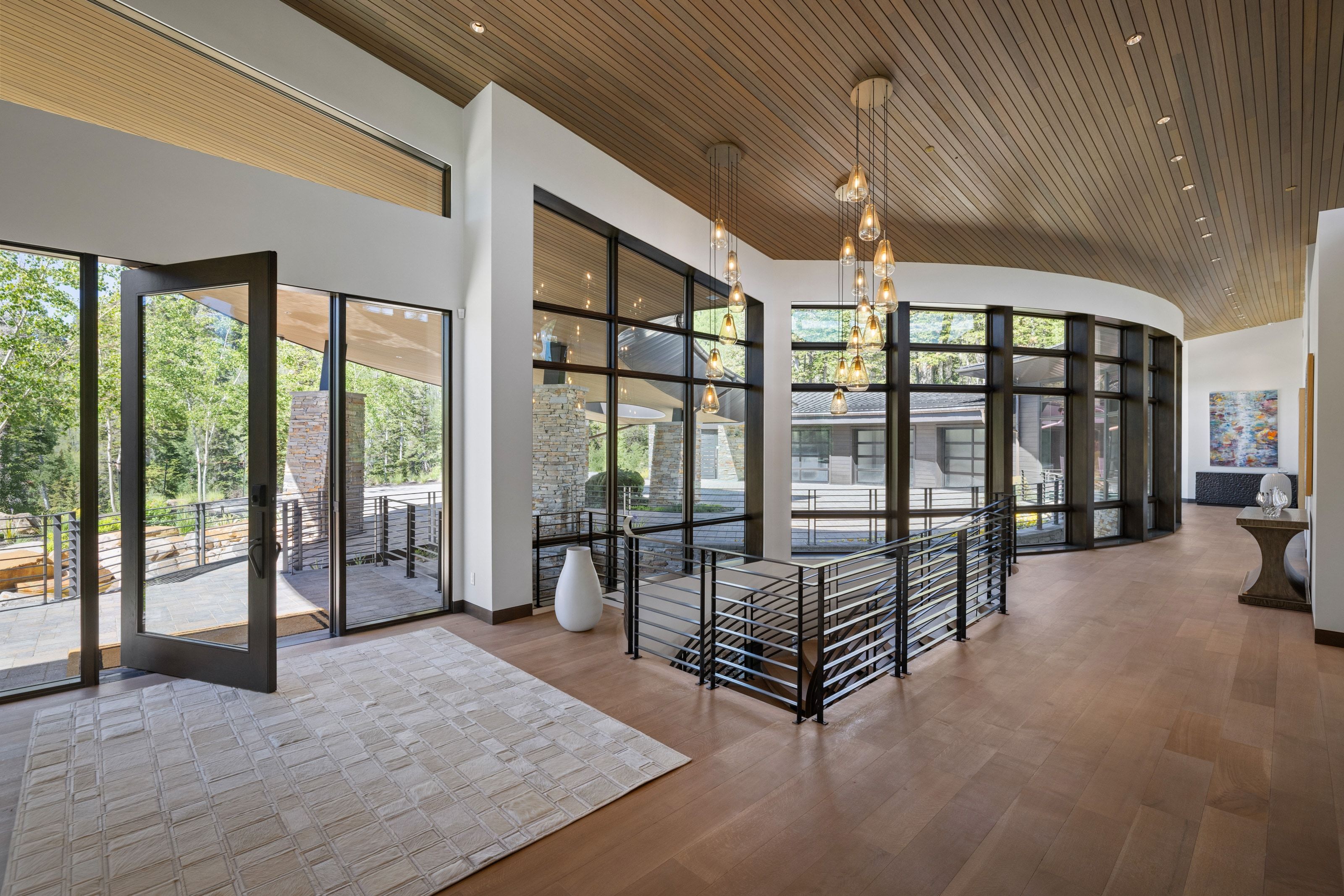 Spacious entryway featuring wood-finish flooring and a slatted wood ceiling