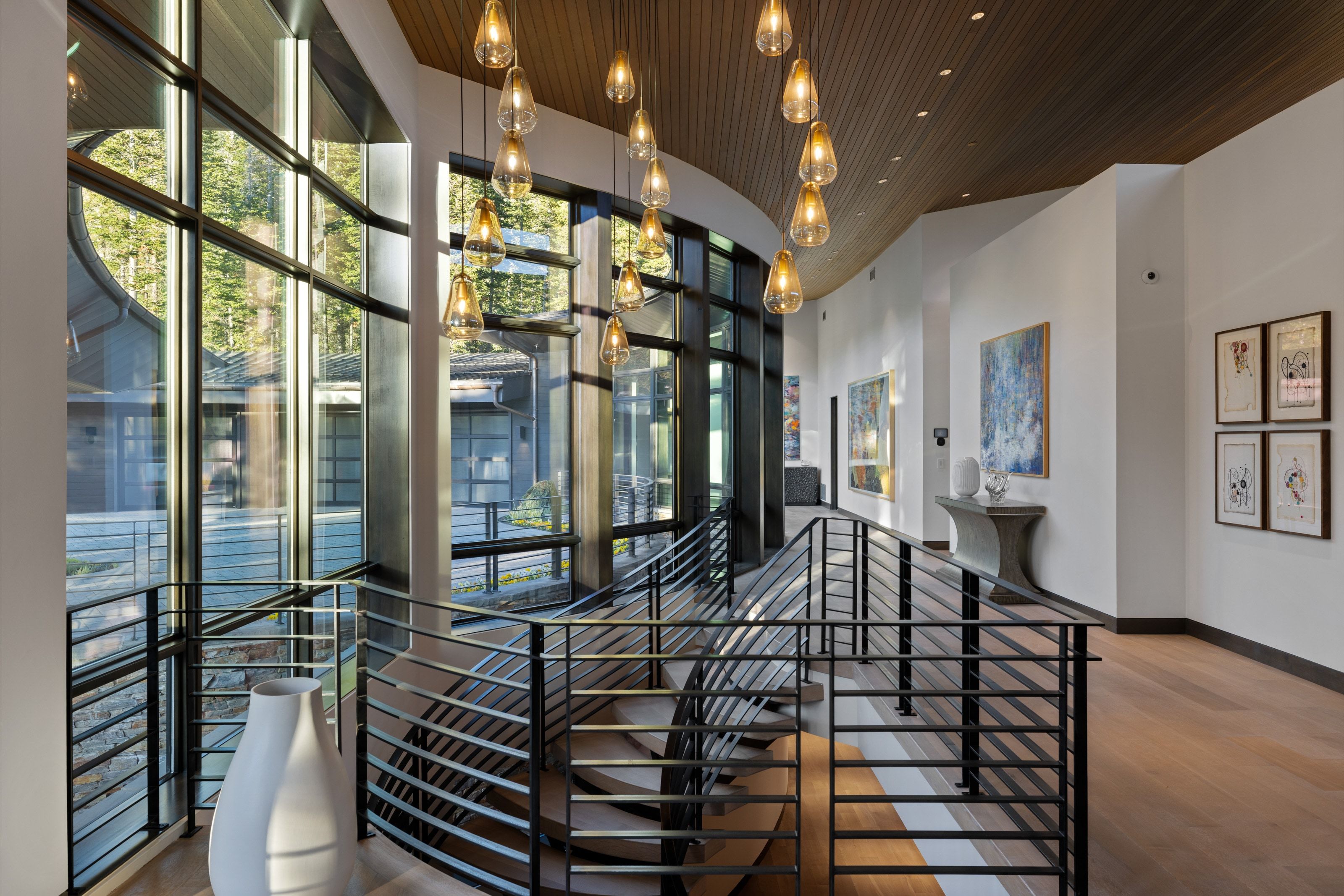 Curved staircase with black metal railings and wood-finish treads