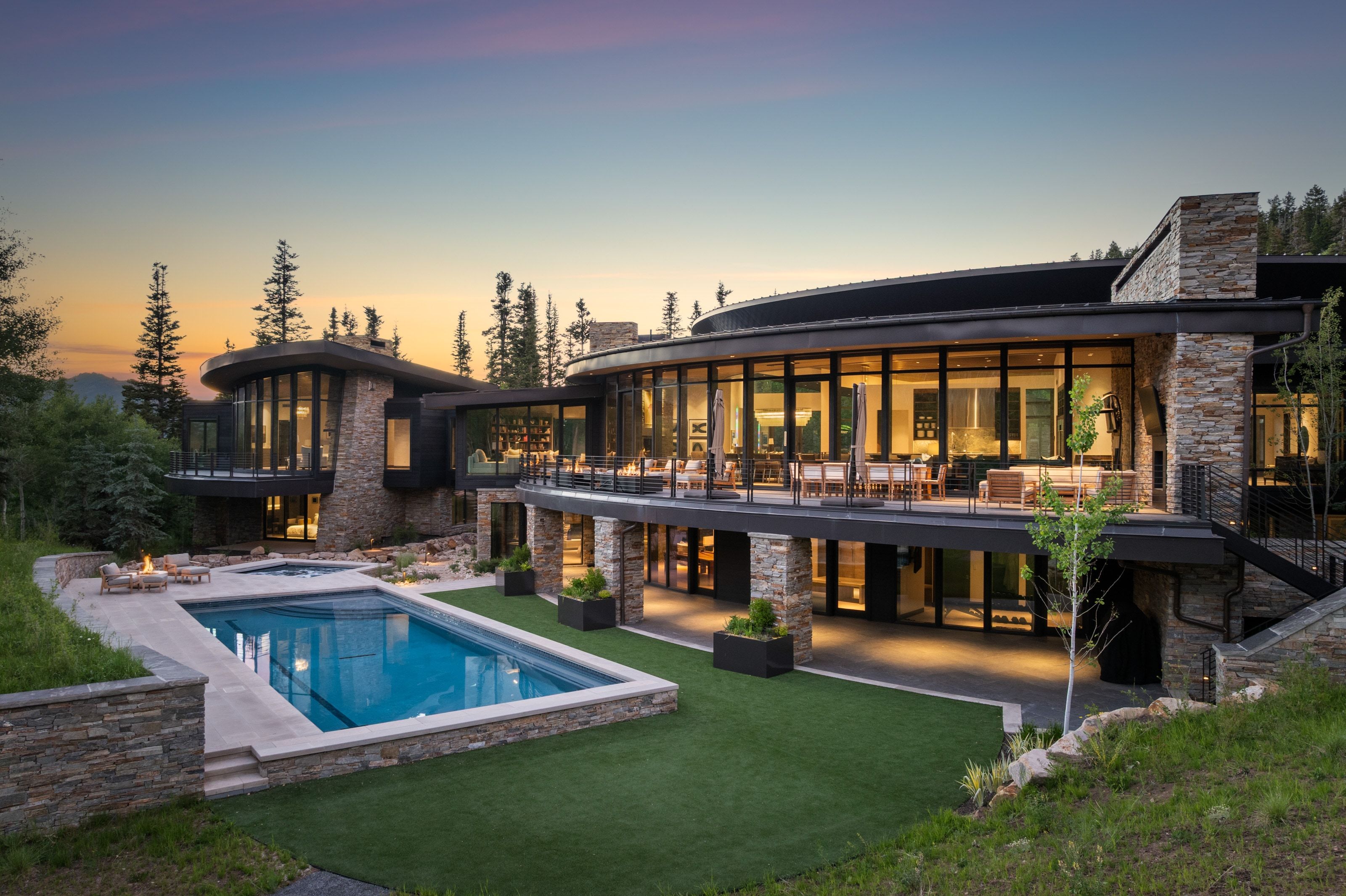 Contemporary multi-level residence featuring extensive glass facades and stone accents