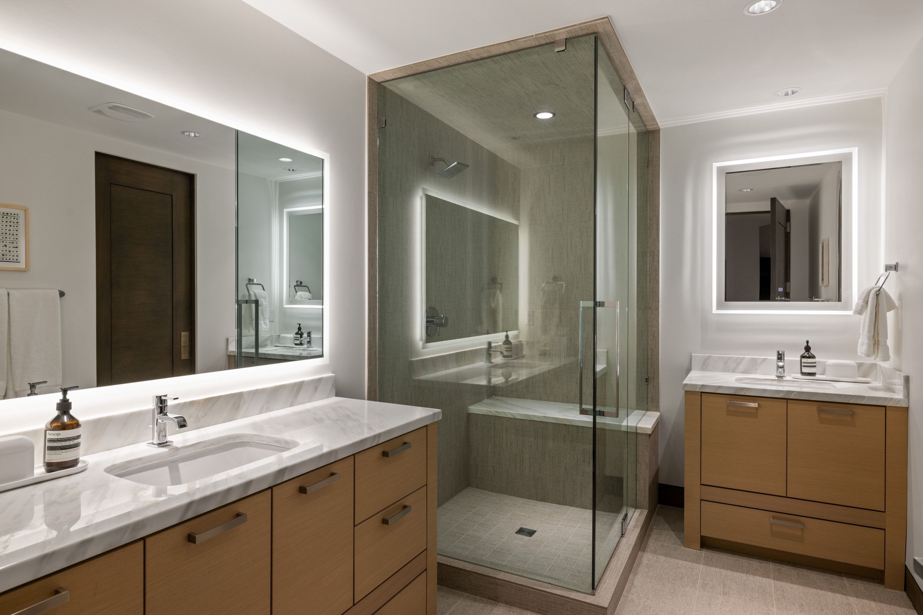 Contemporary bathroom featuring a spacious glass-enclosed shower with a built-in bench