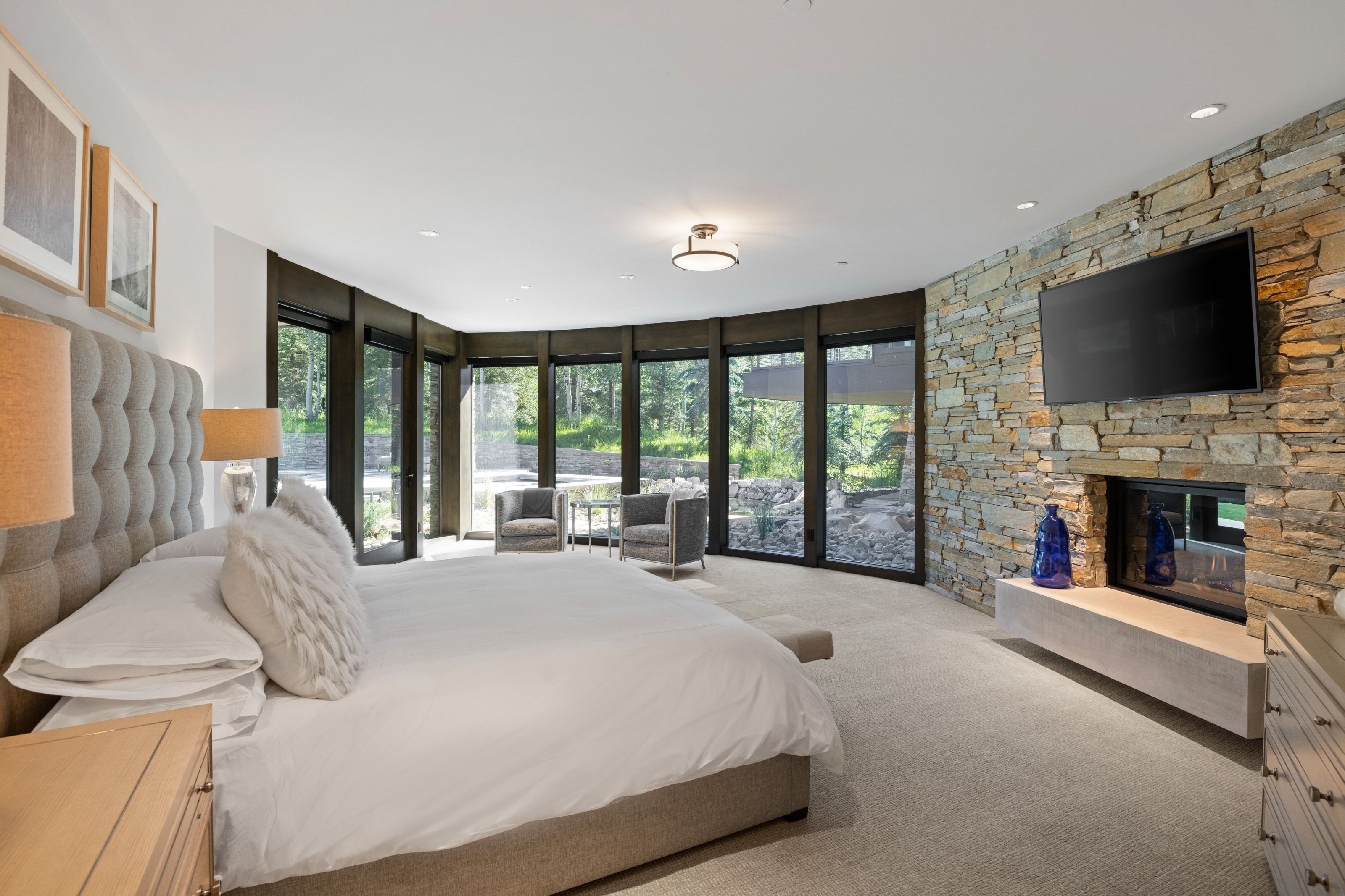 Stone accent wall with a built-in linear fireplace and integrated flat-screen mount