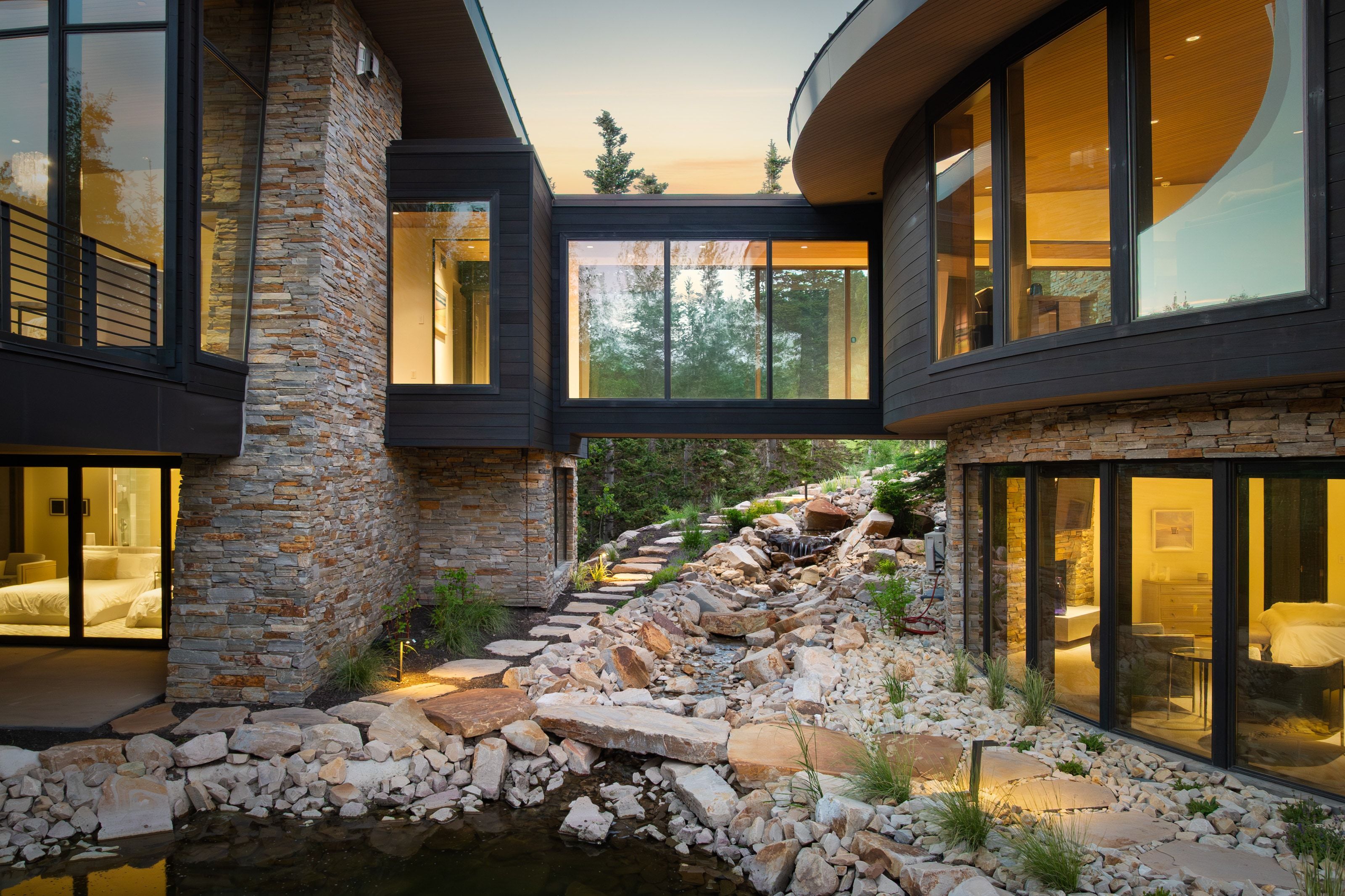 Contemporary architecture featuring extensive stone veneer and dark wood siding