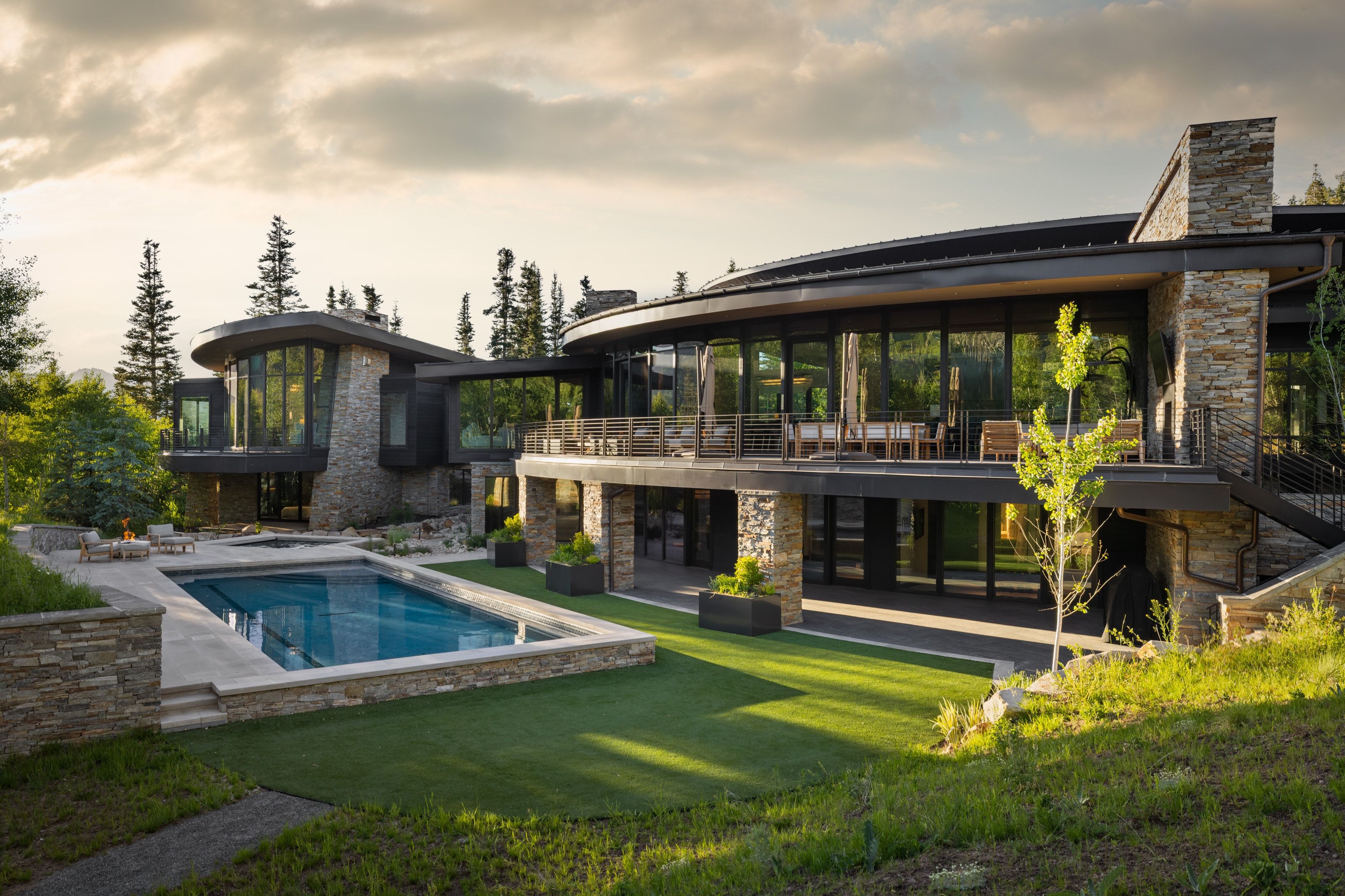 Modern architectural design featuring extensive glasswork and stone cladding