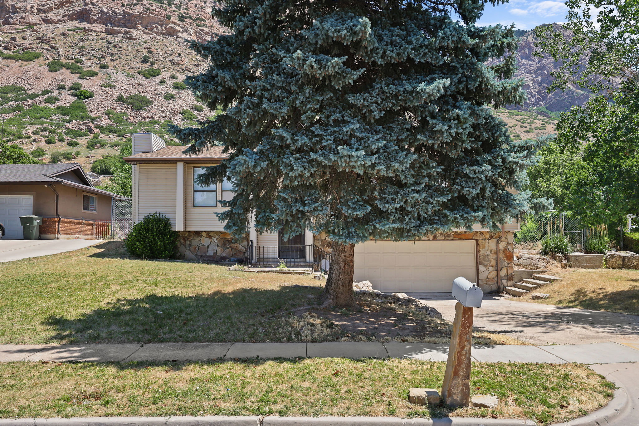 Exterior with stone accent siding and light-colored horizontal siding