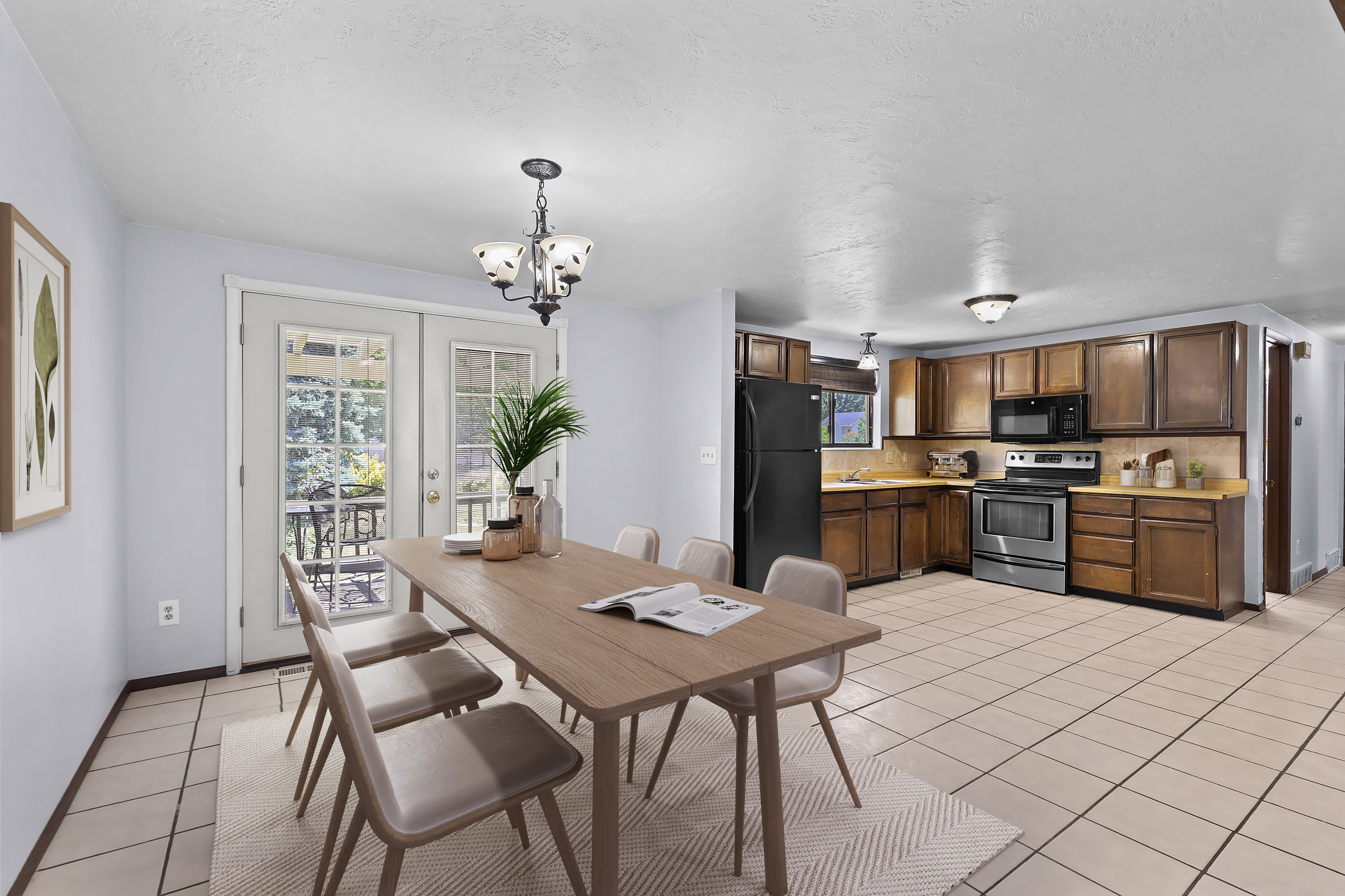 Dining area with tile flooring and double French doors opening to an exterior space