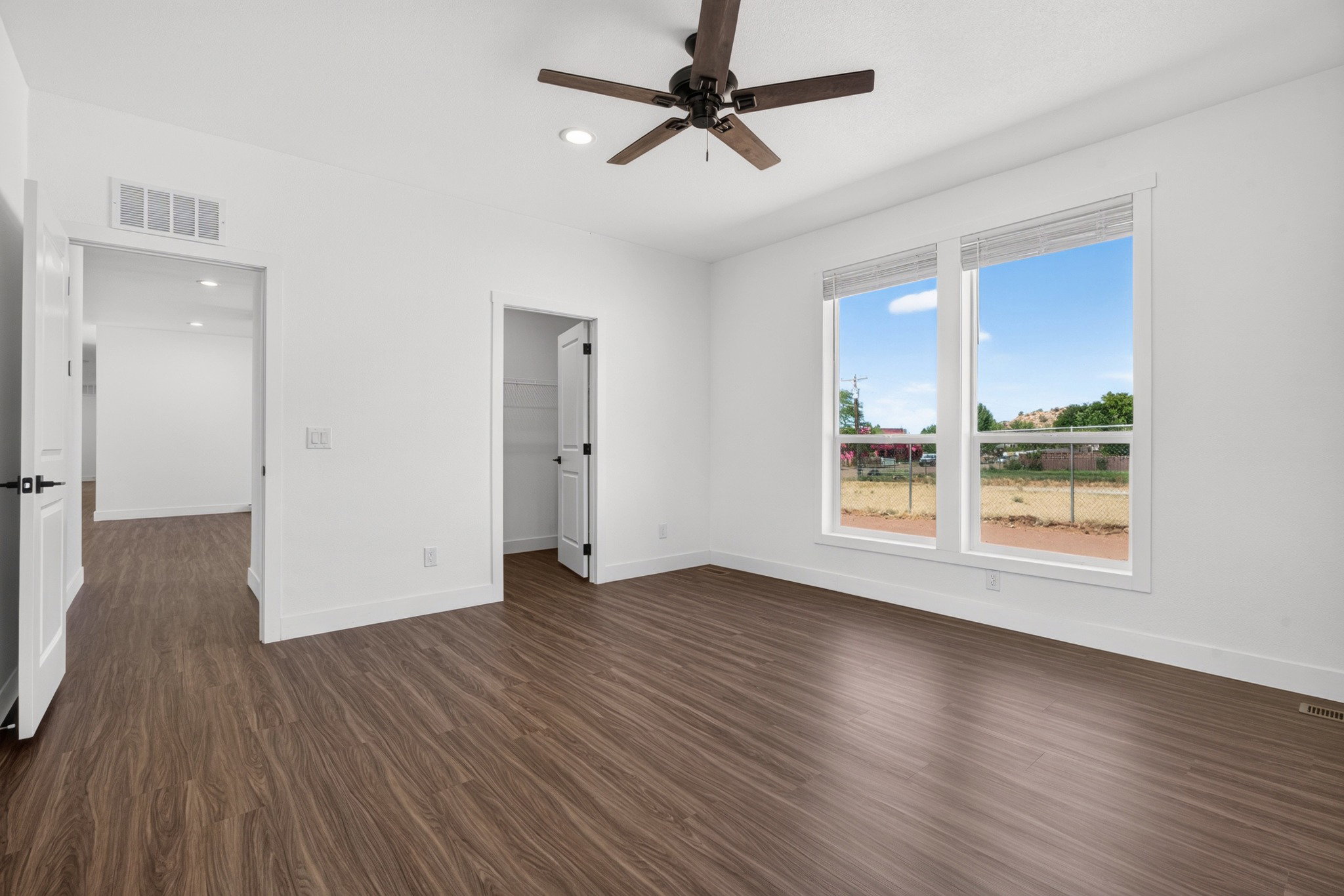 Bright interior featuring wood-finish flooring and white walls