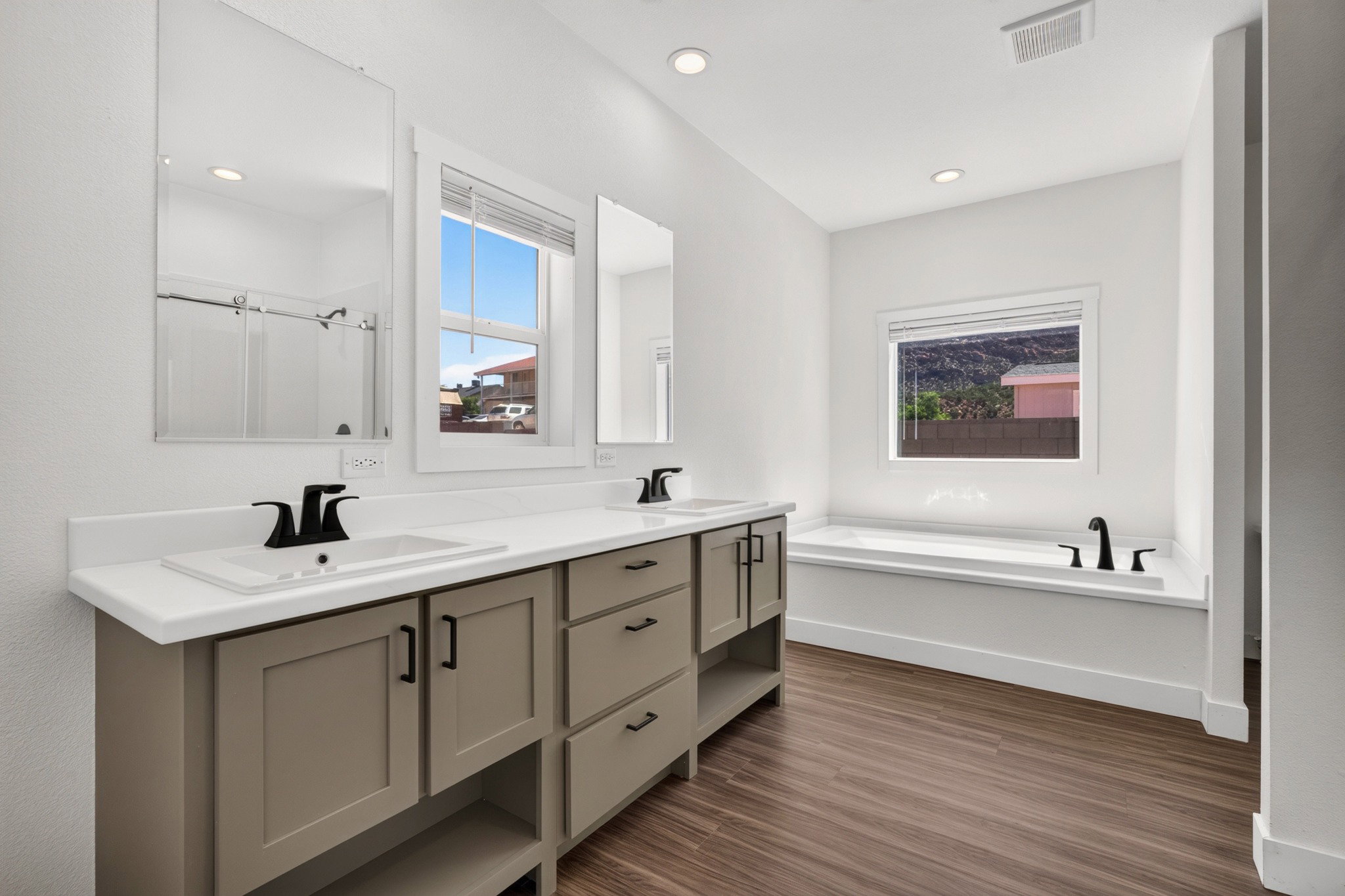 Dual vanity with matte black fixtures and ample storage cabinetry