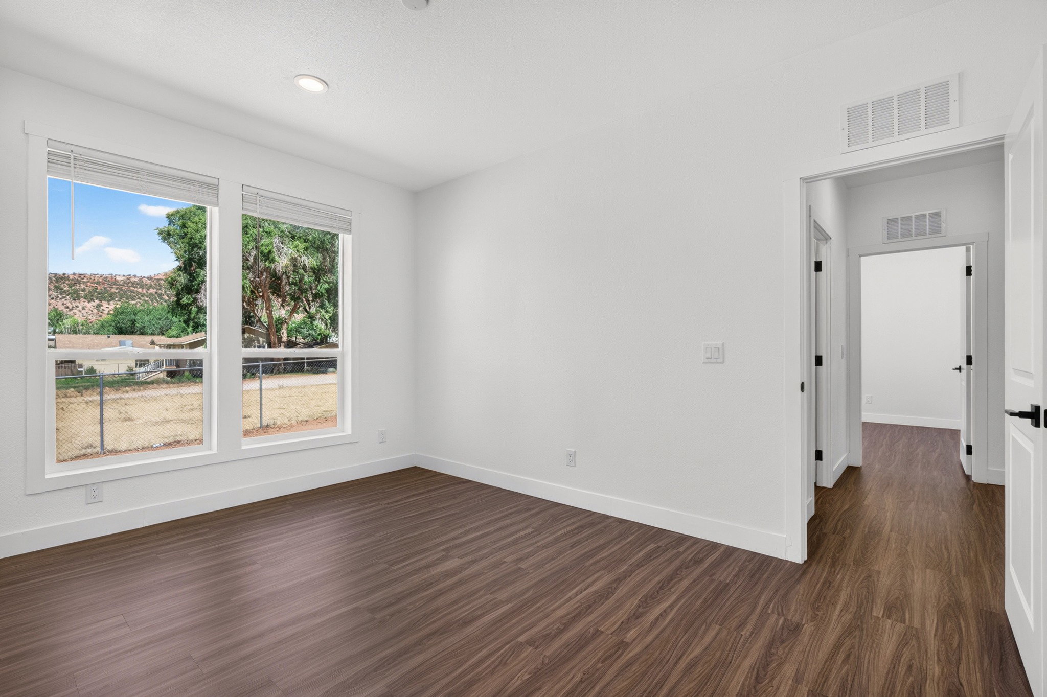 Bright interior space featuring wood-finish flooring, white walls, and recessed lighting