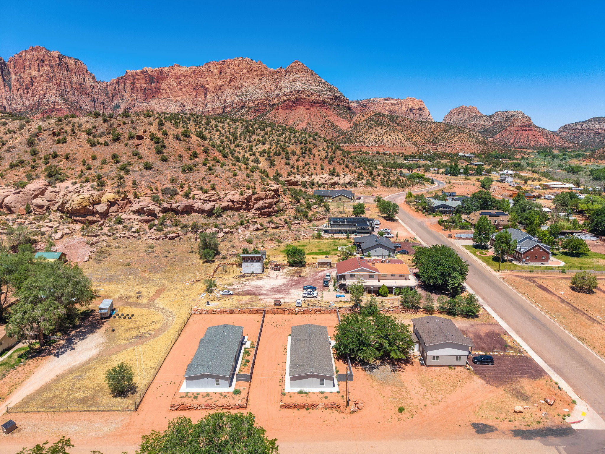 Expansive property featuring clear skies and a red rock mountain backdrop