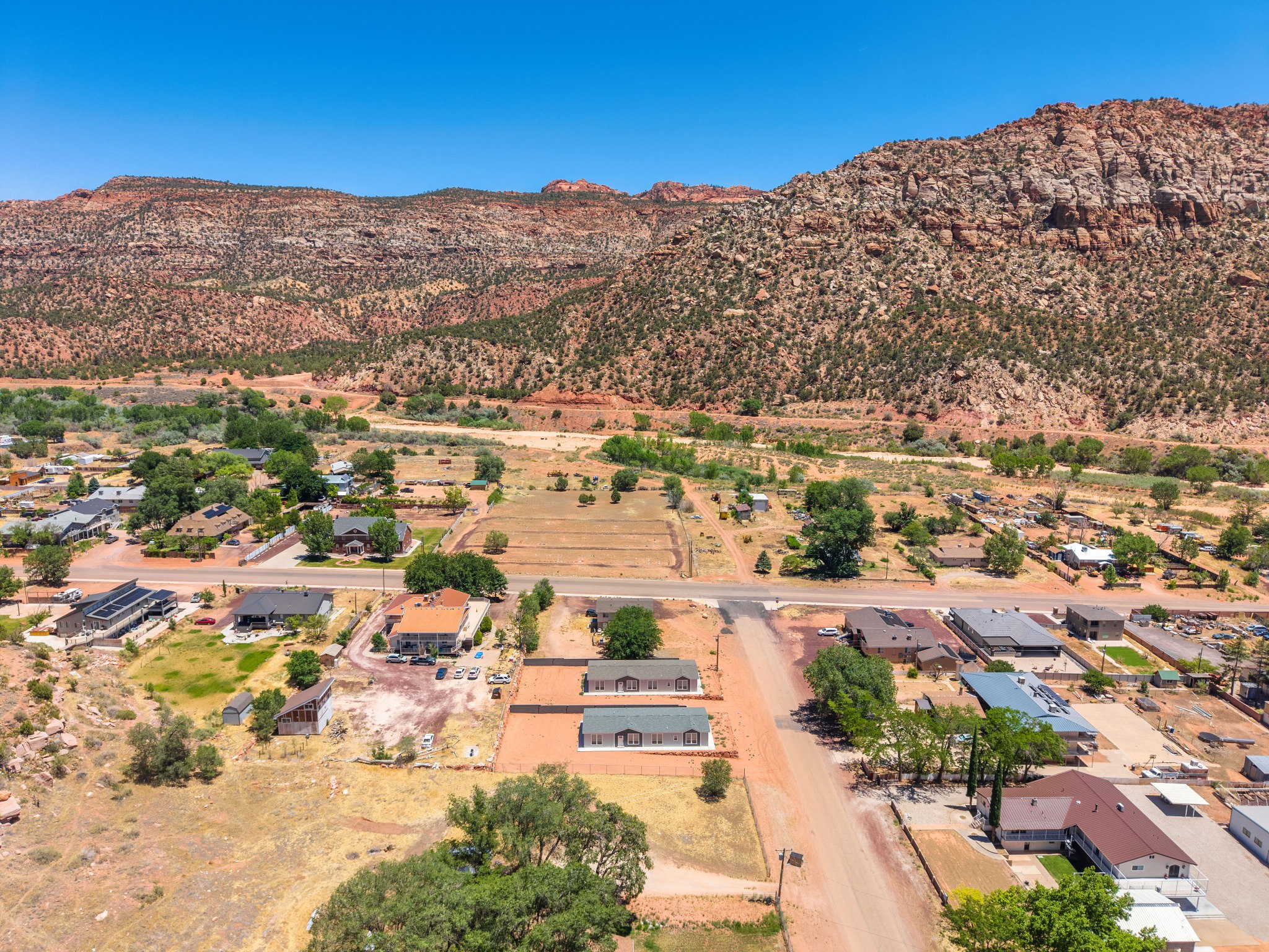 Aerial perspective showcasing a residential area with a prominent mountainous backdrop