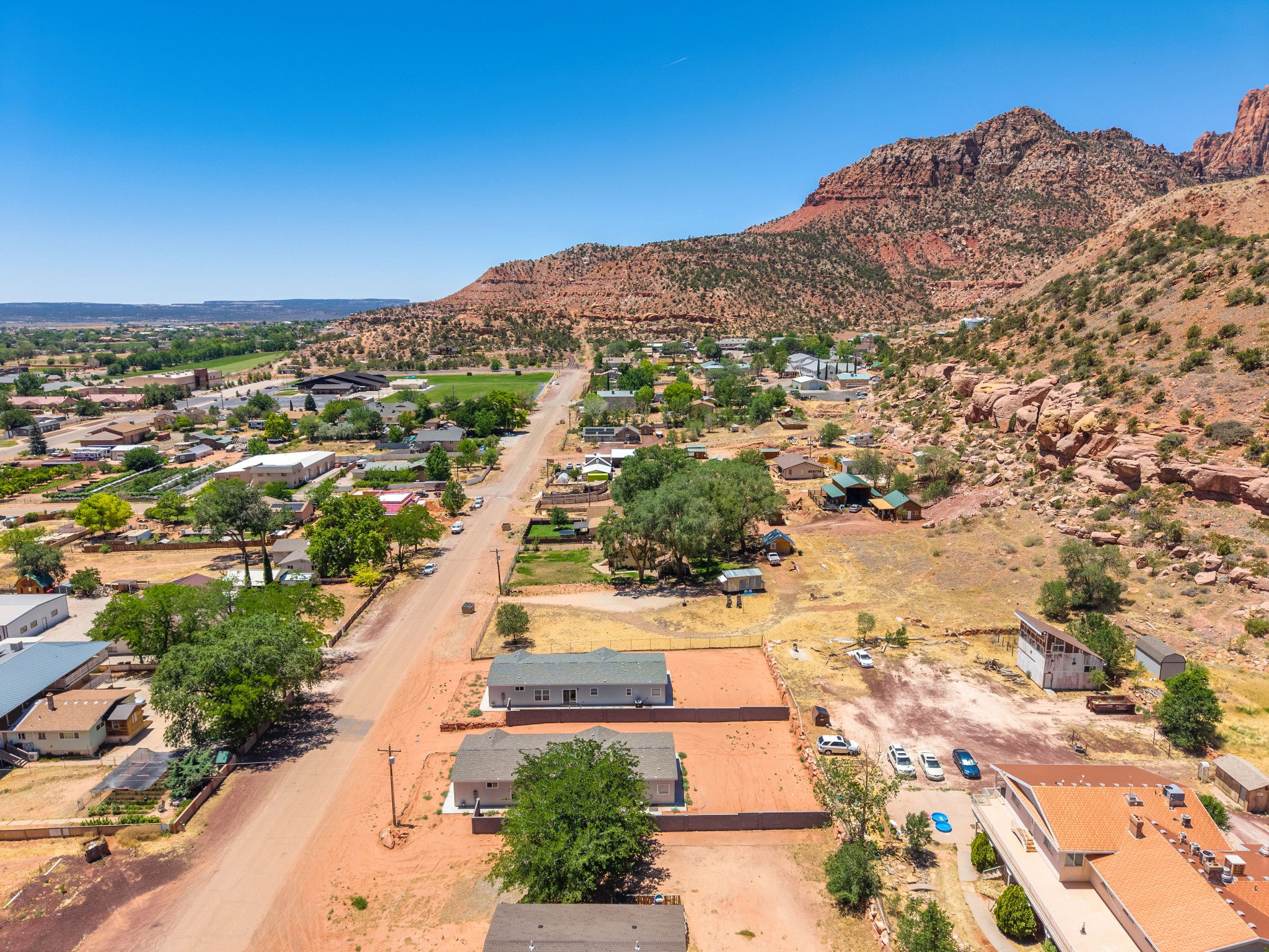 Expansive aerial perspective showcasing a residential area set against a mountainous backdrop